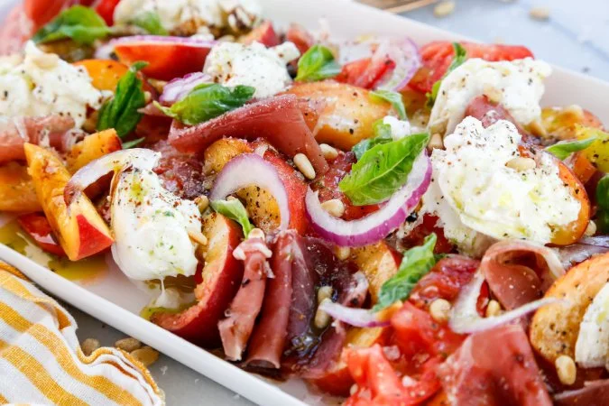 Peach and Tomato Caprese Salad with Pine Nuts, Prosciutto, and Tarragon Oil