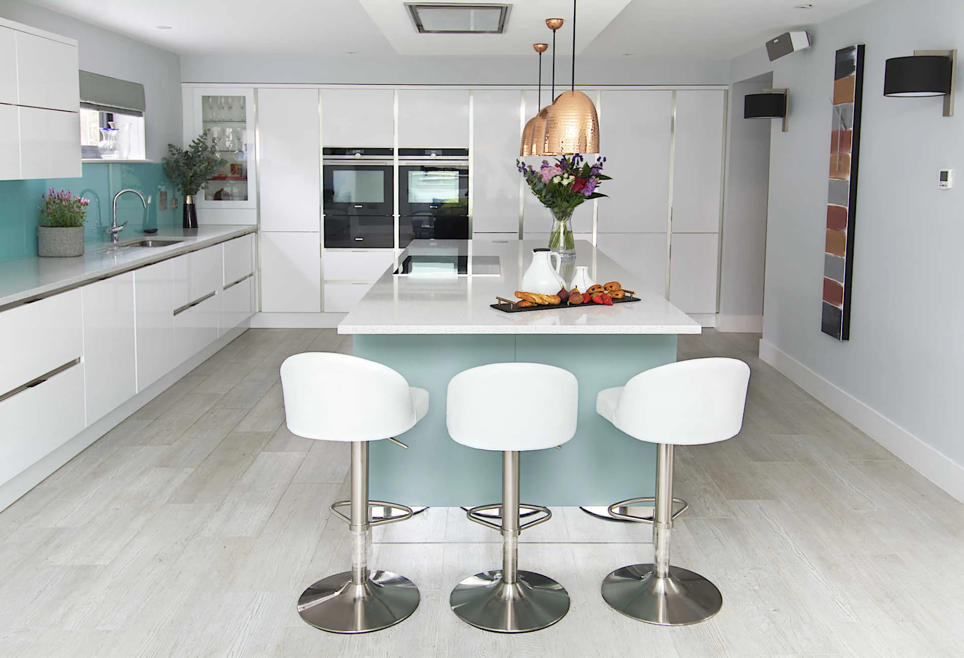 The new open plan kitchen was designed by Evoke Kitchens & Bathrooms in Petersfield and is housed in a new side extension and features a large island providing plenty of worktop space as well as an eating area. A bank of full height cabinets span the back wall and house a number of appliances. A lighting scheme was developed, providing a flexible design to suit the time of day/night. 