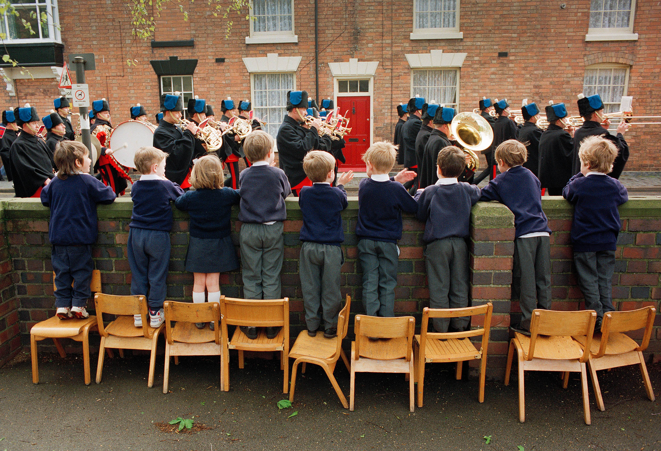School children watch a marching brass band celebrating the anniversary of Shakespeare's birthday in Stratford-upon-Avon