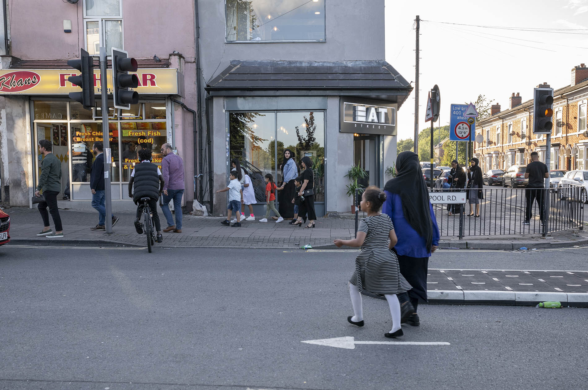 People in the Balsall Heath area of Birmingham heading out to restaurants in the early evening. Birmingham has seen a spike in cases of Covid-19.