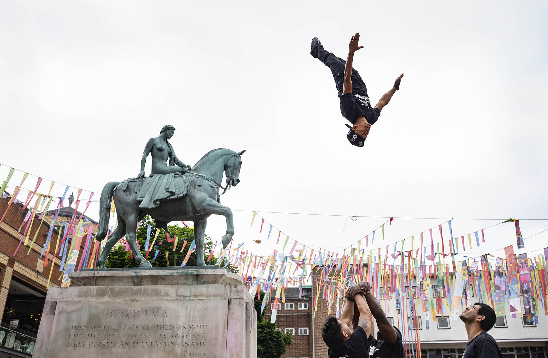 Acrobats from the circus Circolombia stop by the Lady Godiva statue in Coventry. They are performing in the UK City of Culture festivities.
