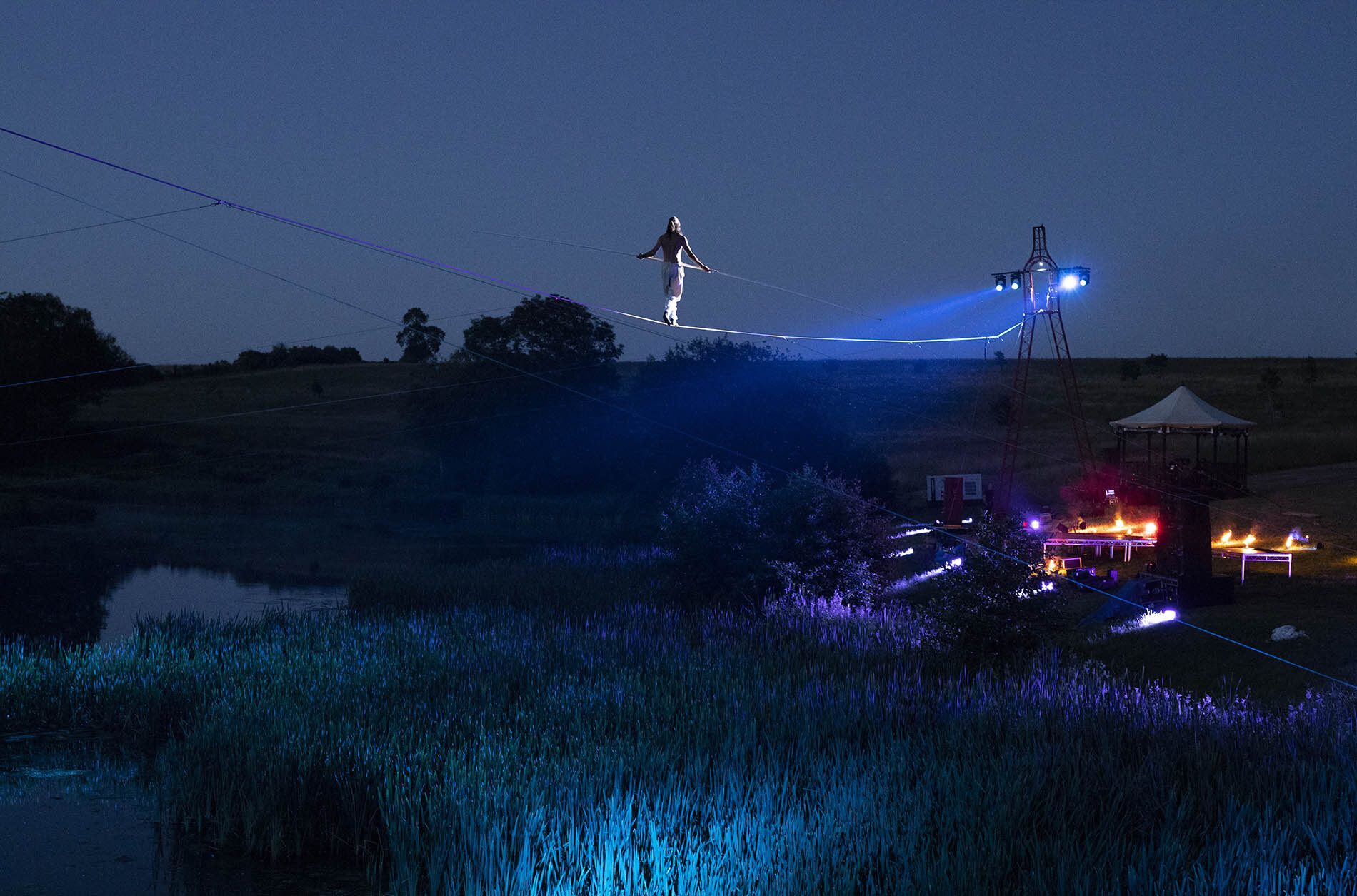 Tightrope walker Chris Bullzini performing at Compton Verney Gardens, Warwickshire.