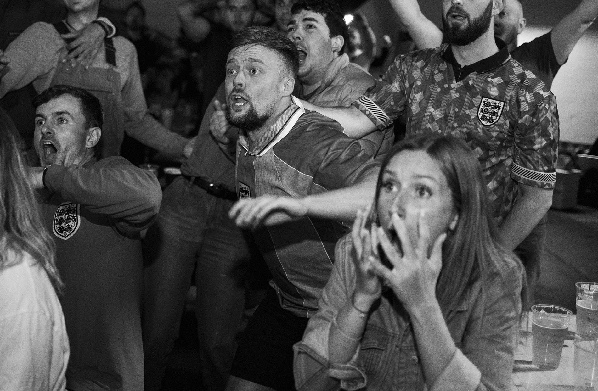  England fans in a pub react while watching the Euro 2020 semi-final against Denmark  