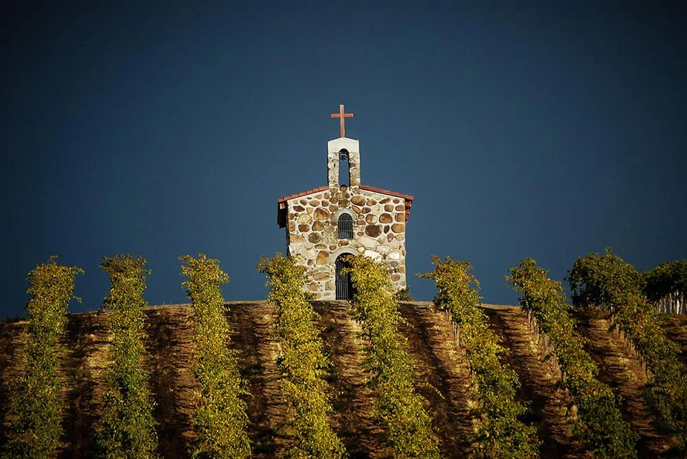 With Mt. Adams looming in the background, the iconic prayer chapel at Red Willow Vineyard stands atop the hillside that is planted with the oldest Syrah grapes in the State of Washington. Courtesy photo