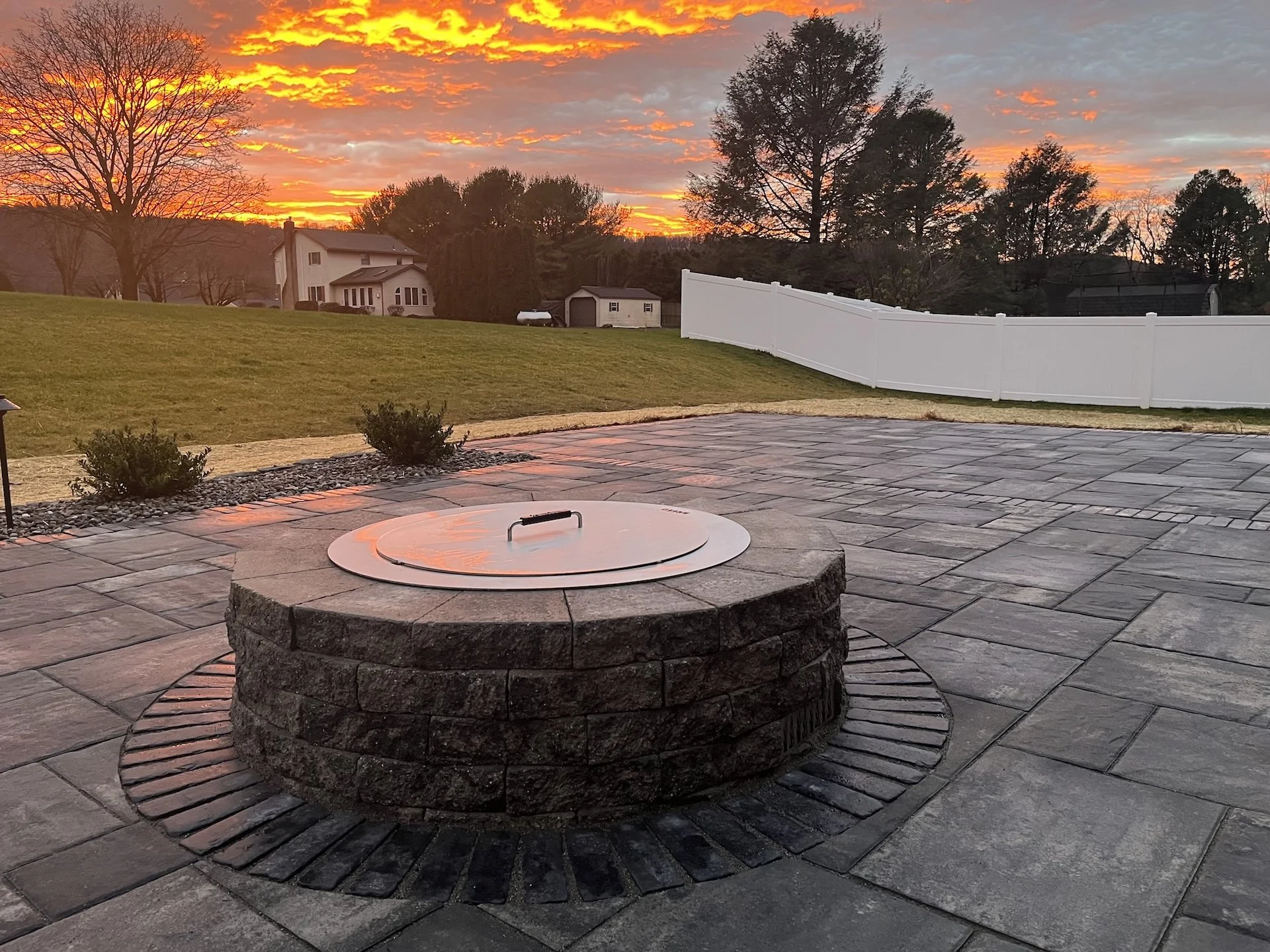 What a Fire Pit Contractor in Hamburg, PA, Builds Under the Stone