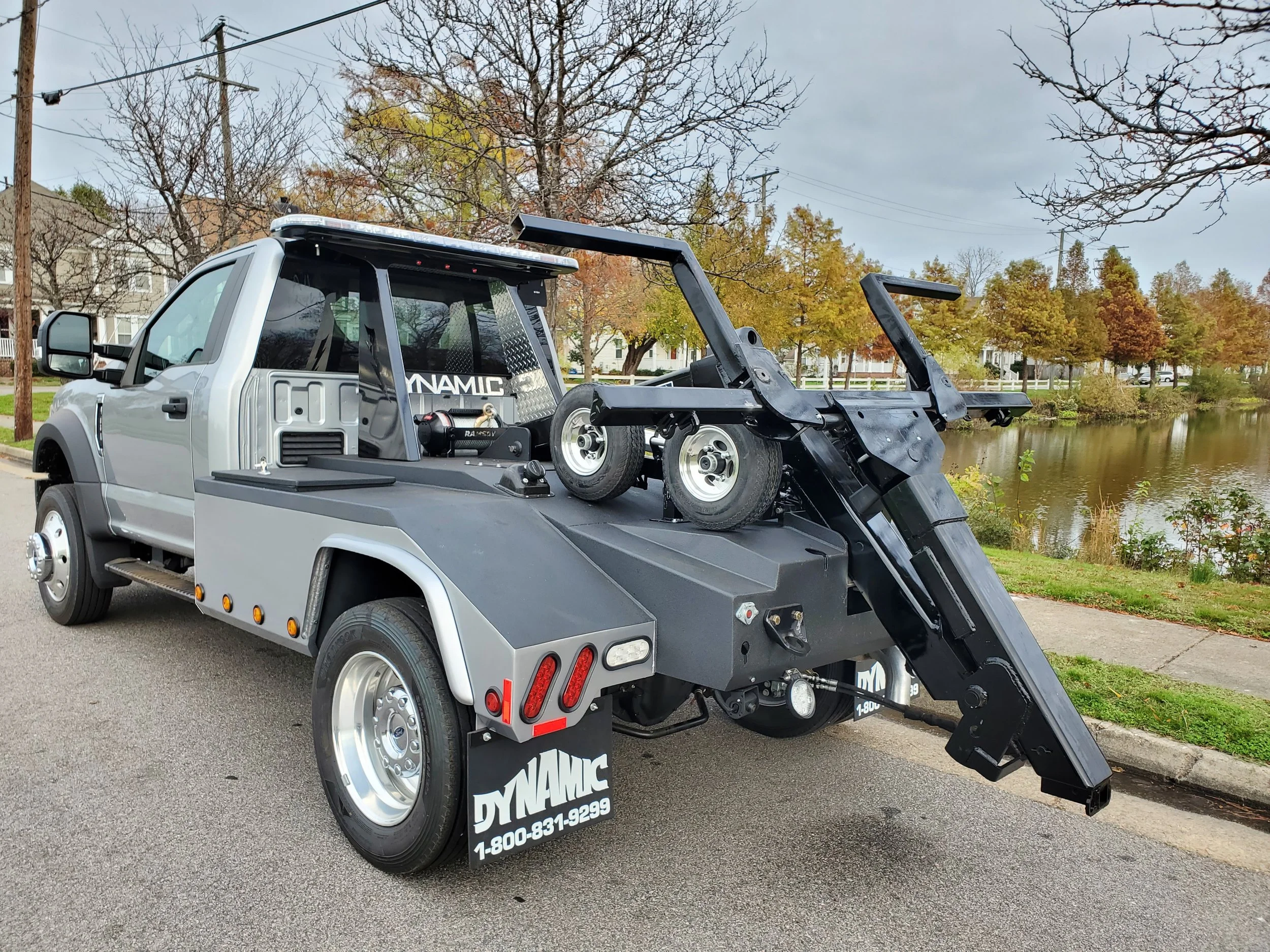 Dynamic Tow truck with a flatbed.