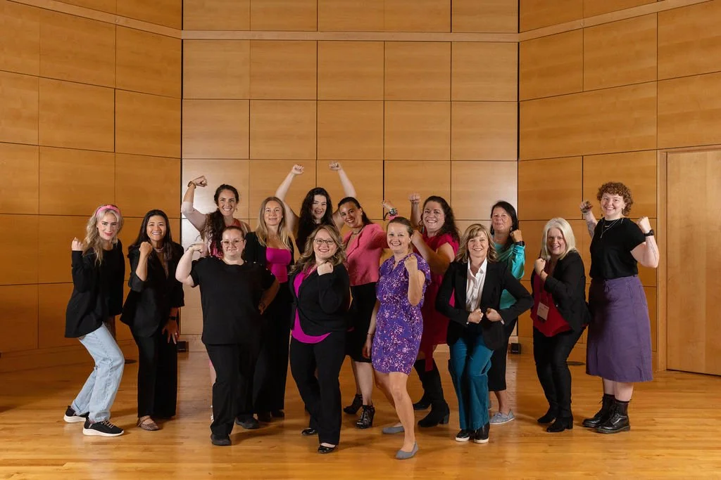 Board of Directors posing for photo on stage