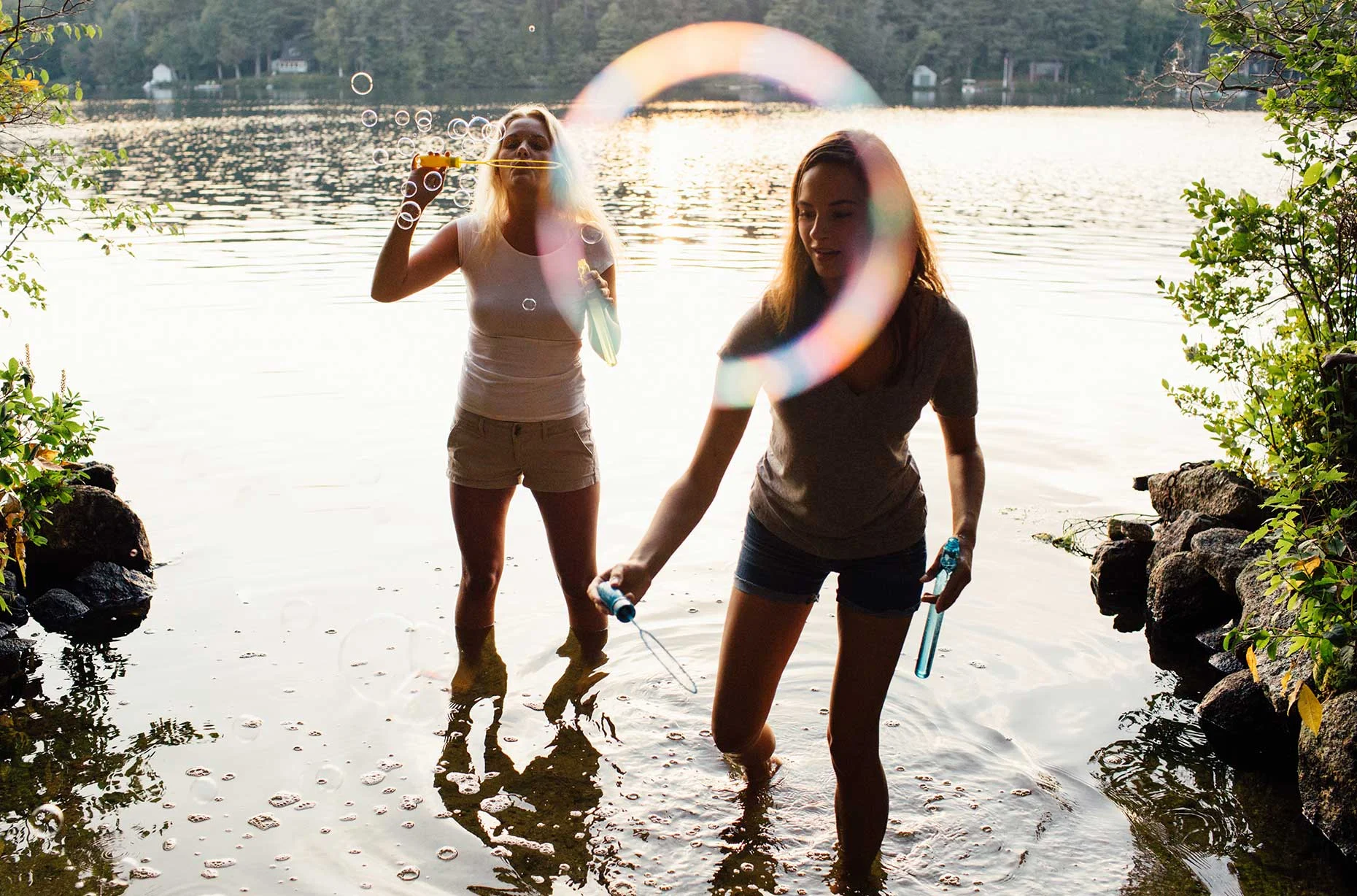 girls_blowing_bubbles_summer_lake.jpg