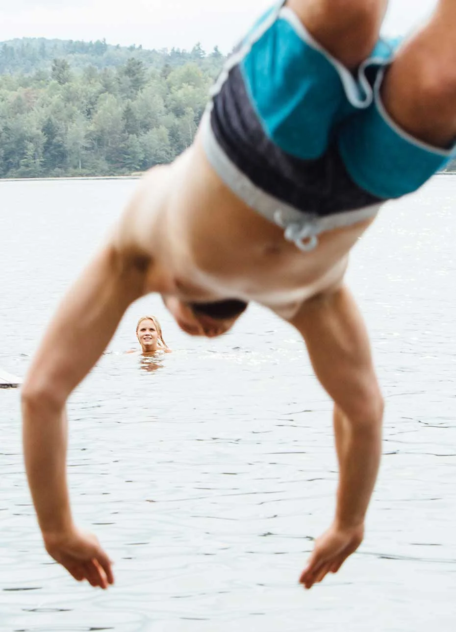 man_jumping_into_lake_new_hampshire.jpg