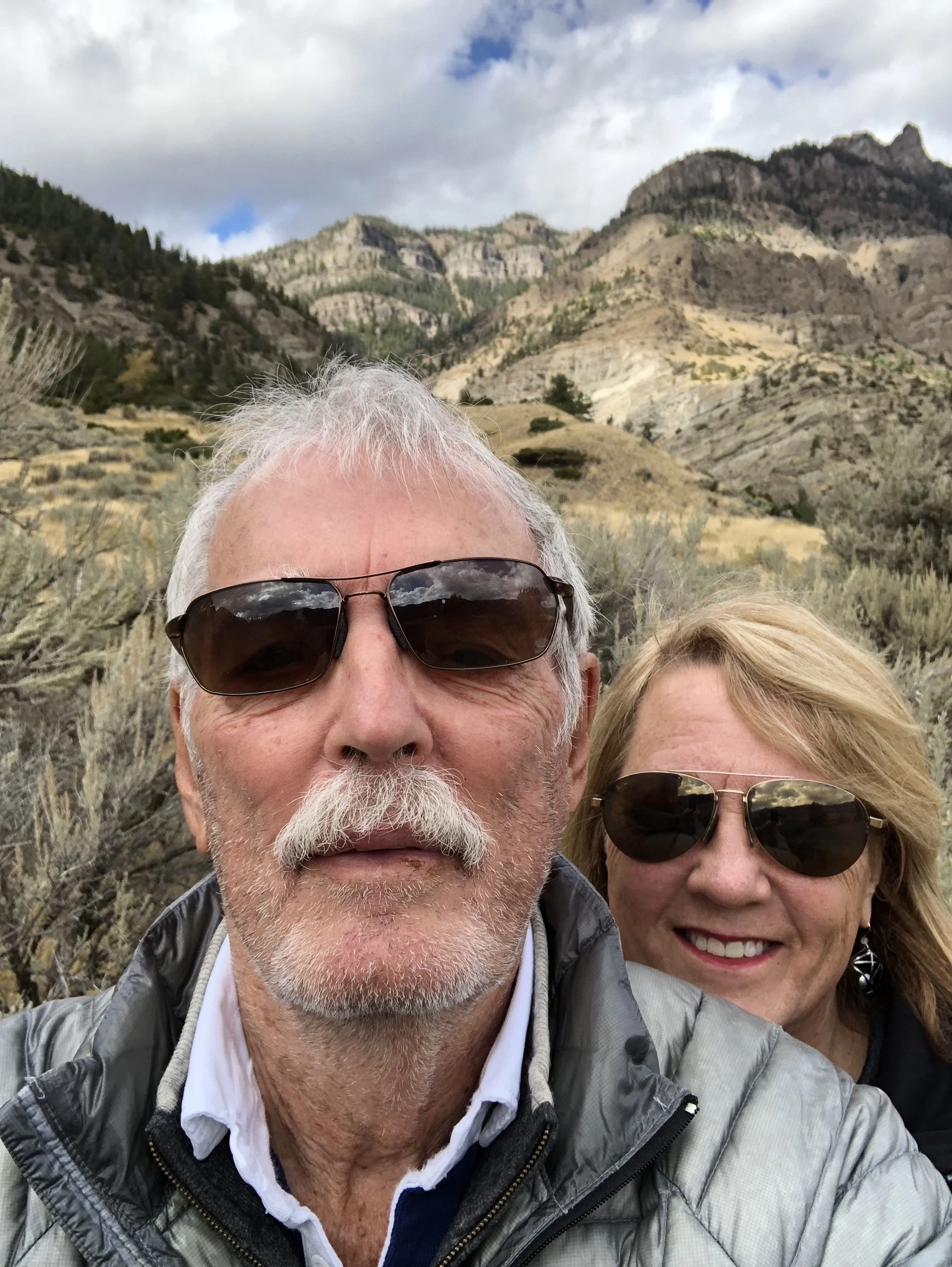 Holly and Lisa in the Wyoming sagebrush, mountains behind them