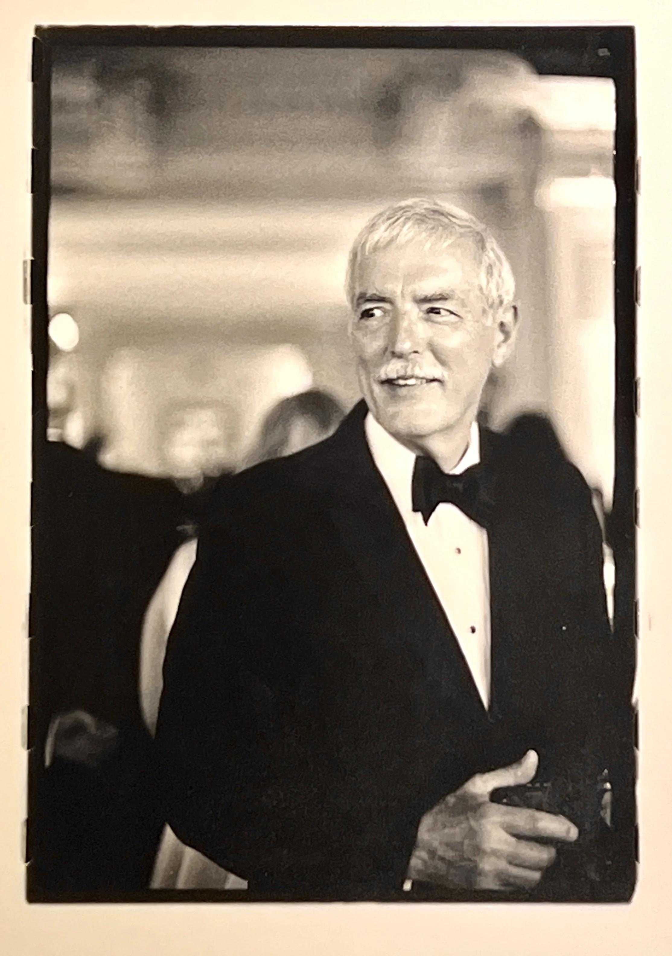 Black-and-white portrait of Holly in a tuxedo