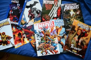 Marvel comics laying in a pile on a blue background.
