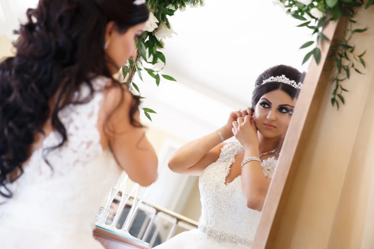 Elegant Pasadena Wedding to Make You Swoon bride adding final jewelry touches.jpg
