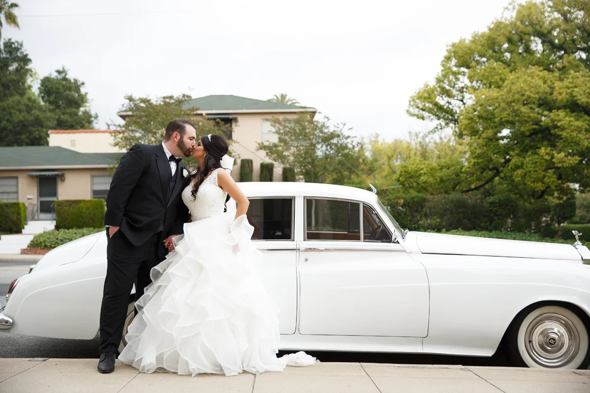 Elegant Pasadena Wedding to Make You Swoon bride and groom in front of classic limo.jpg