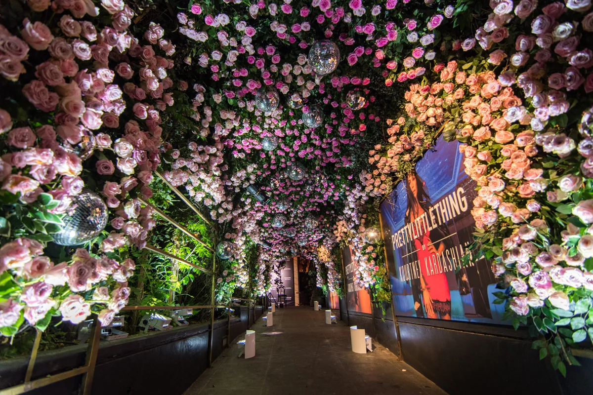 PrettyLittleThing PLT X Kourtney Kardashian Collection Celebrity Launch Party entrance full of flowers.jpg