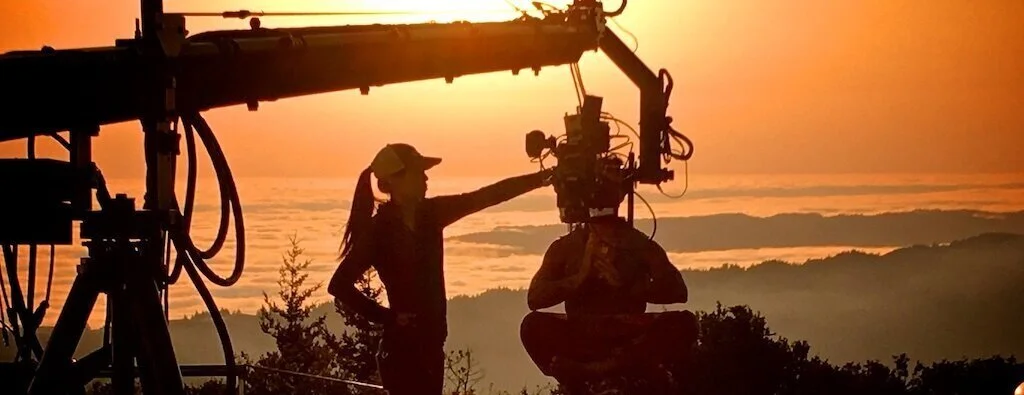 Beautiful+orange+sunset+on+mountaintop+overlooking+fog+filled+Marin%2C+CA+In+background+with+camera+boom%2C+camera+assistant%2C+and+actor%2C.jpg