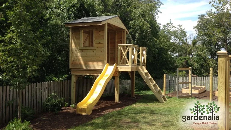 Wooden tree house project with mulching next to an edible garden!