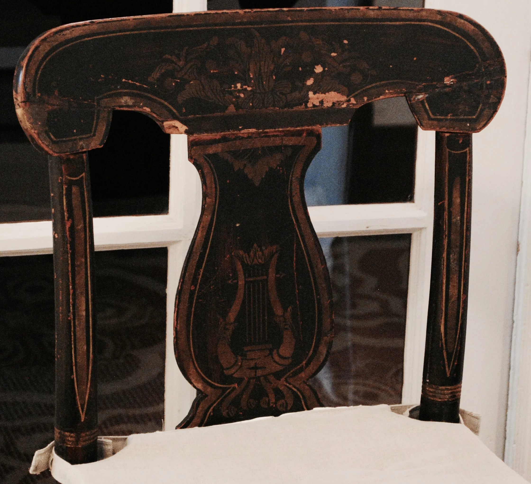 A Lyre-back Hitchcock side chair of Victorian vintage.
