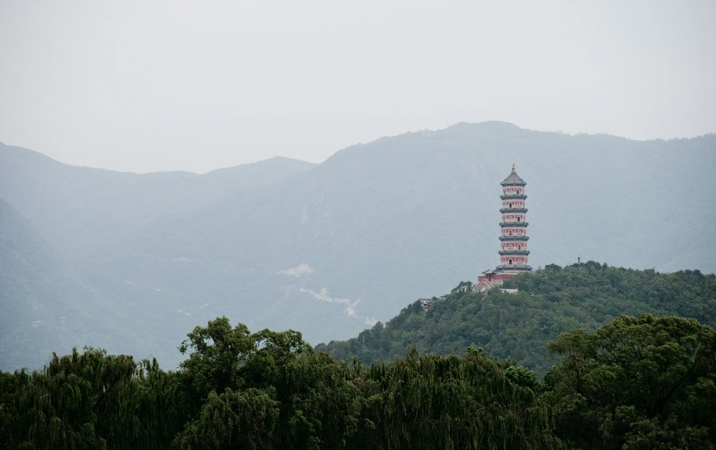 The Summer Palace is one of the most tranquil spots in China. It was a serene, awe-inspiring - yet ostentatious - experience to visit the artificially made lake and surrounding hills. This photograph of the Jade Peak Pagoda on Jade Spring Hill was made in 2016, while boating on the man-made Kunming Lake inside the Summer Palace grounds. If you ever find yourself in Beijing, don't miss out of visiting this sometimes ignored site - it's worth the drive.