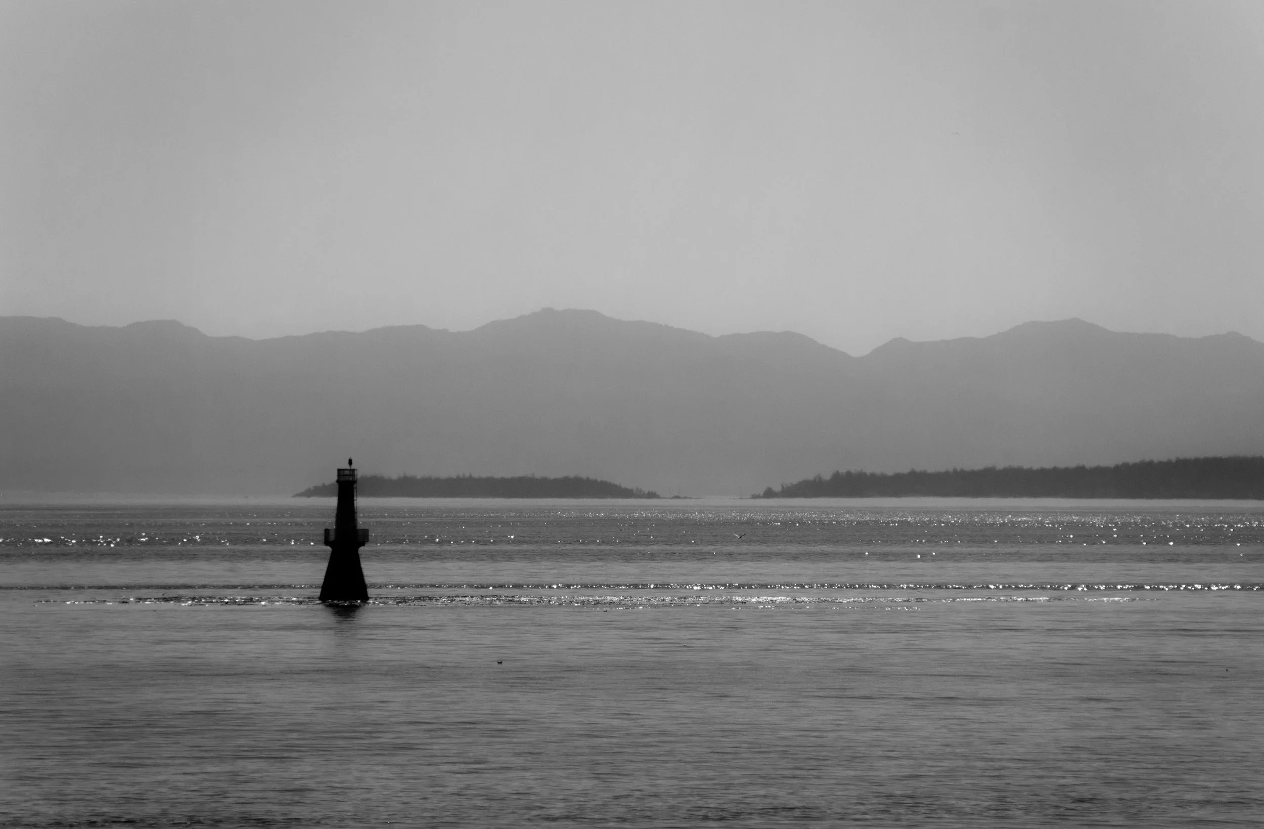 A lighthouse in shadow in the Haro Strait in BC