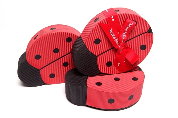 three paper ladybug shaped boxes