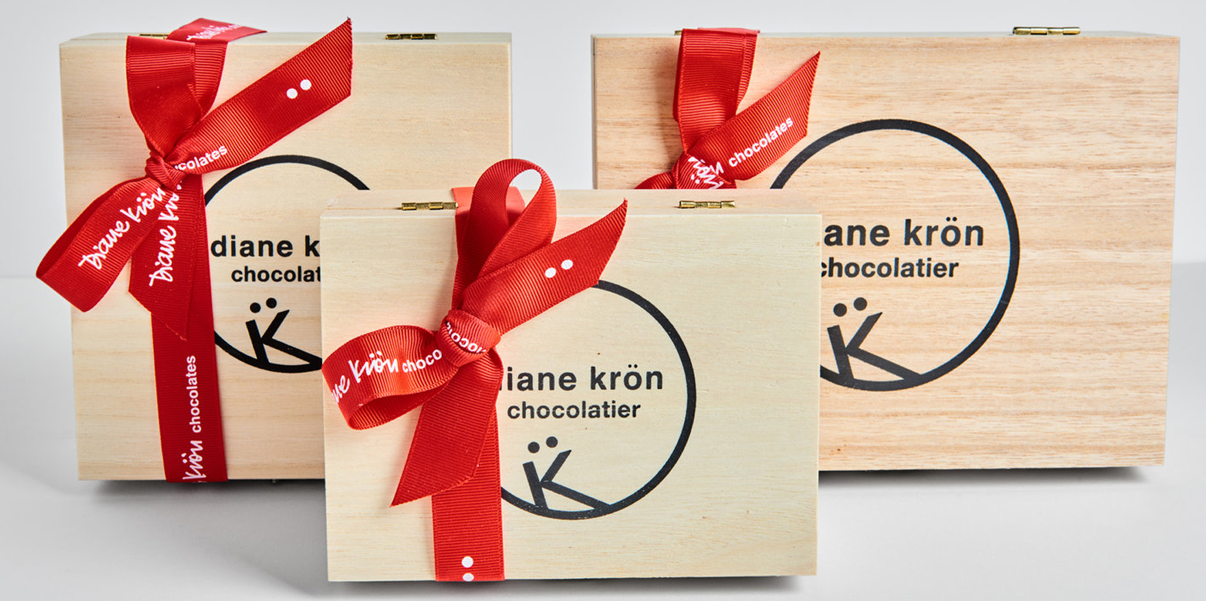  Three wooden boxes each tied with red ribbon 