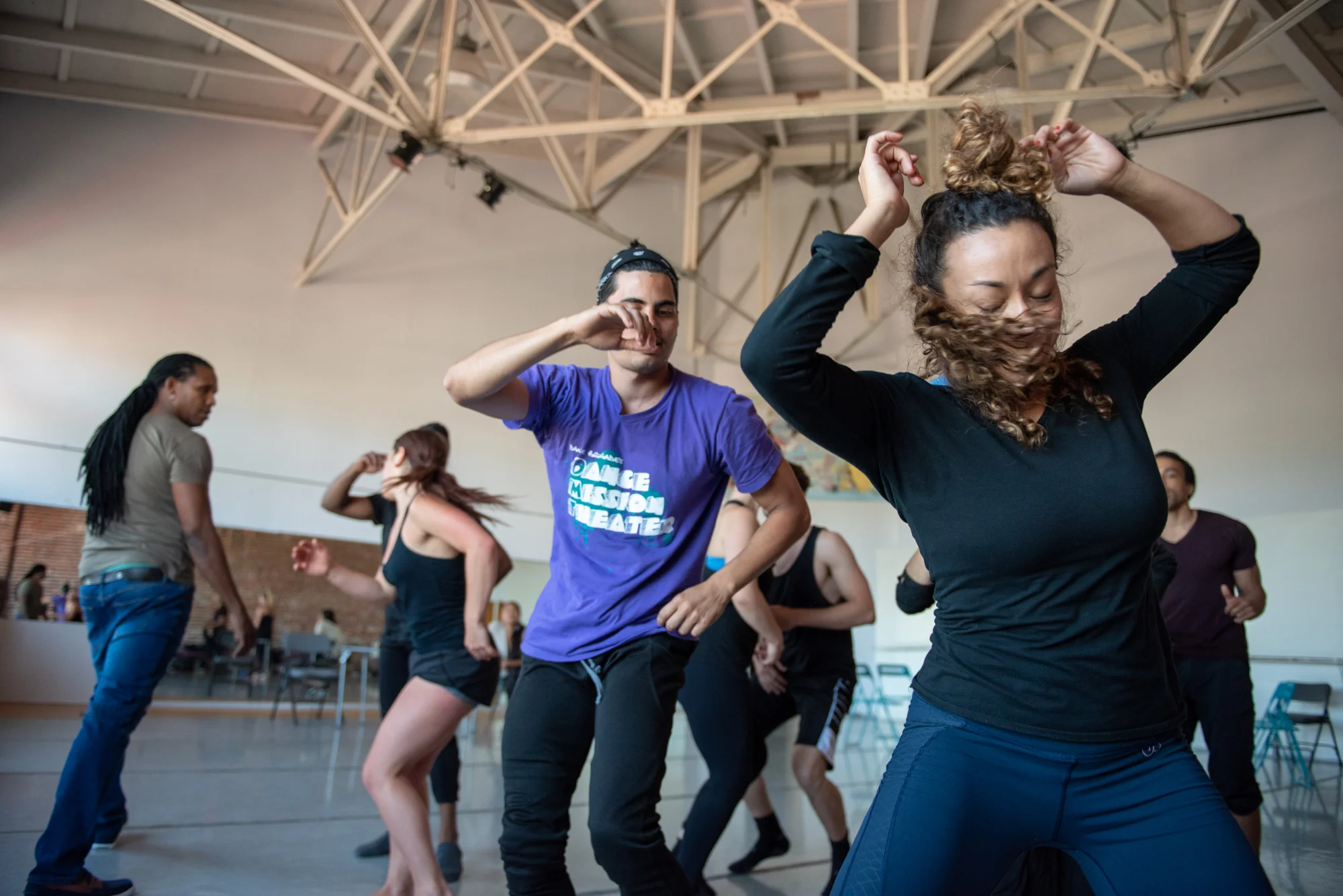 Dancers Adonis Martin Quiñones (center wearing purple shirt) and Jillian Miller (right) dance a rumba with other members of the Alayo Dance Company, as artistic director Ramon Ramos Alayo looks on, during a rehearsal for the upcoming Cuba Caribe Festival, in San Francisco on Friday, June 1, 2018. | Rosa Furneaux, Special To The Chronicle