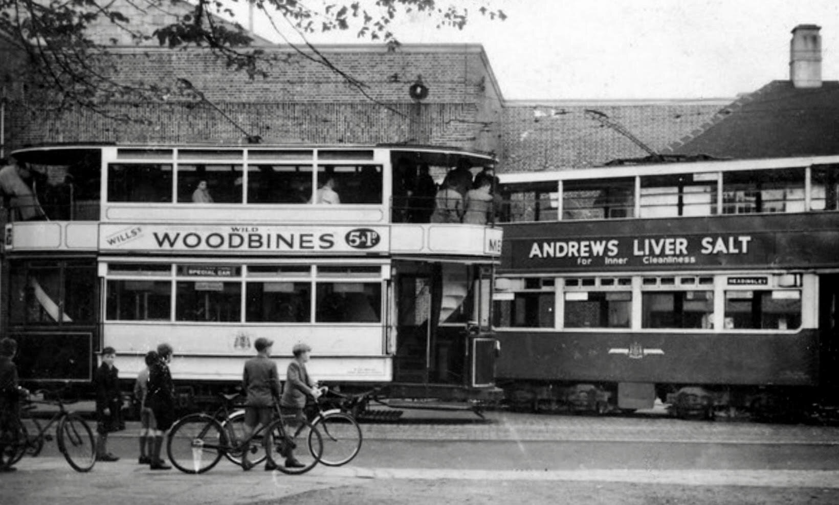 To left, open-balcony electric tram, and to right, electric tram, leaving New Depot, 1949