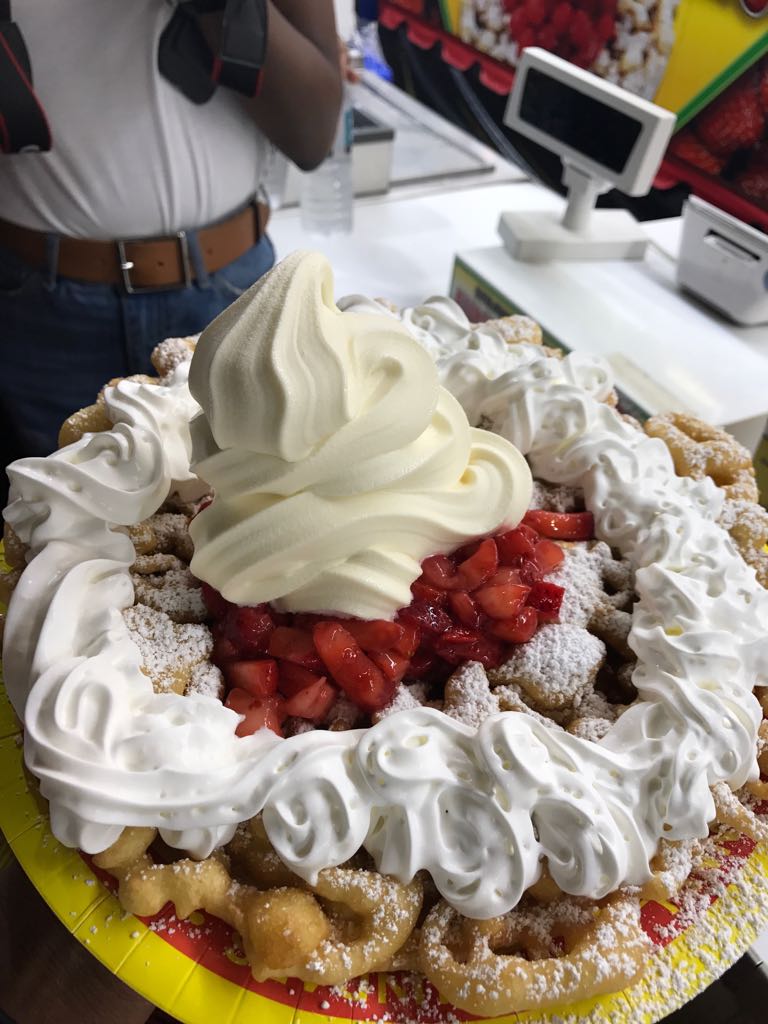 Funnel cake with cream, ice cream and strawberries 
