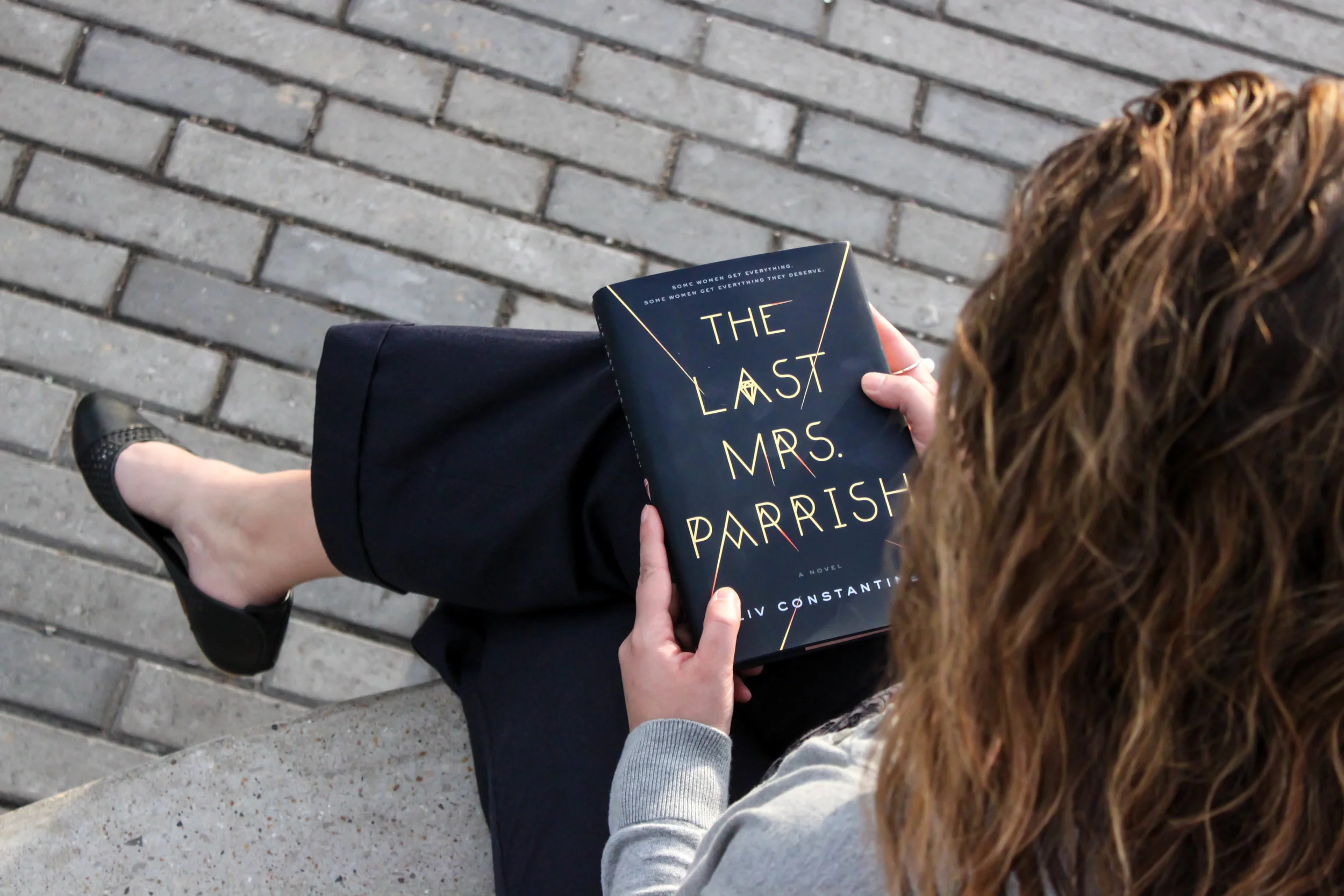 Reading The Last Mrs. Parrish by Liv Constantine outside the Fox Theatre in St. Louis, MO