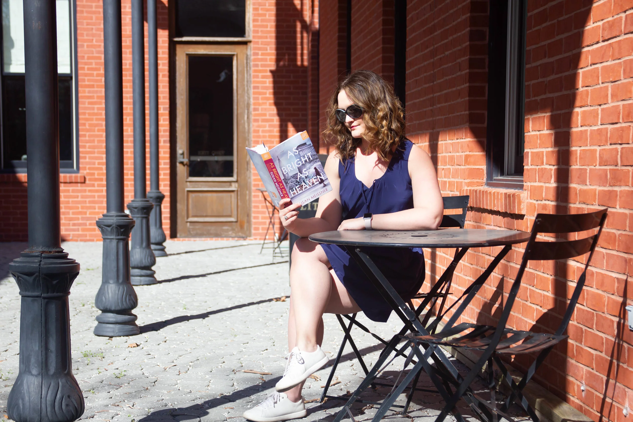 Reading As Bright As Heaven by Susan Meissner in New Town at St. Charles, MO (but it could be a cafe in France, no?)