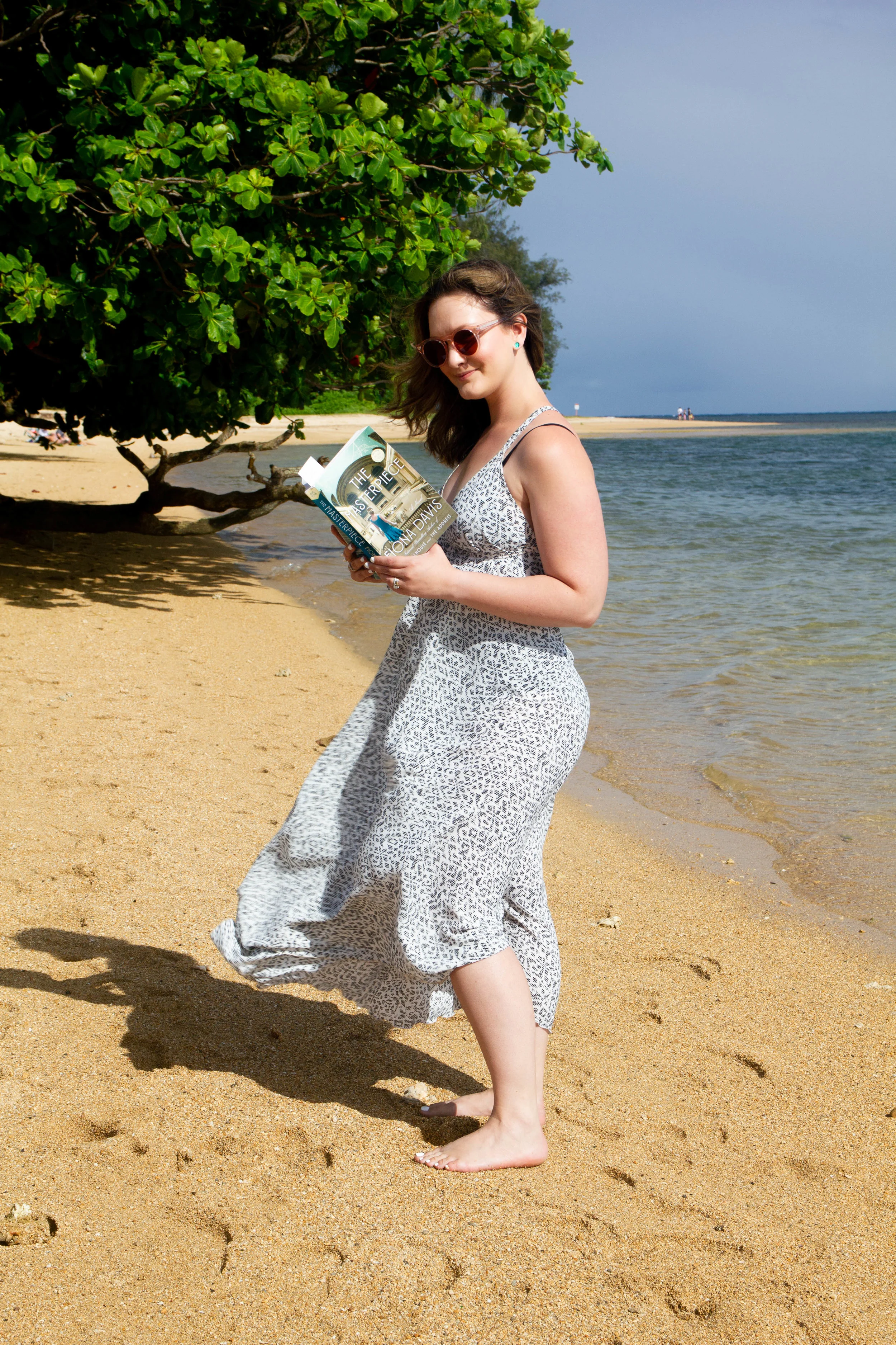 Reading The Masterpiece on Anini Beach in Kauai, Hawaii