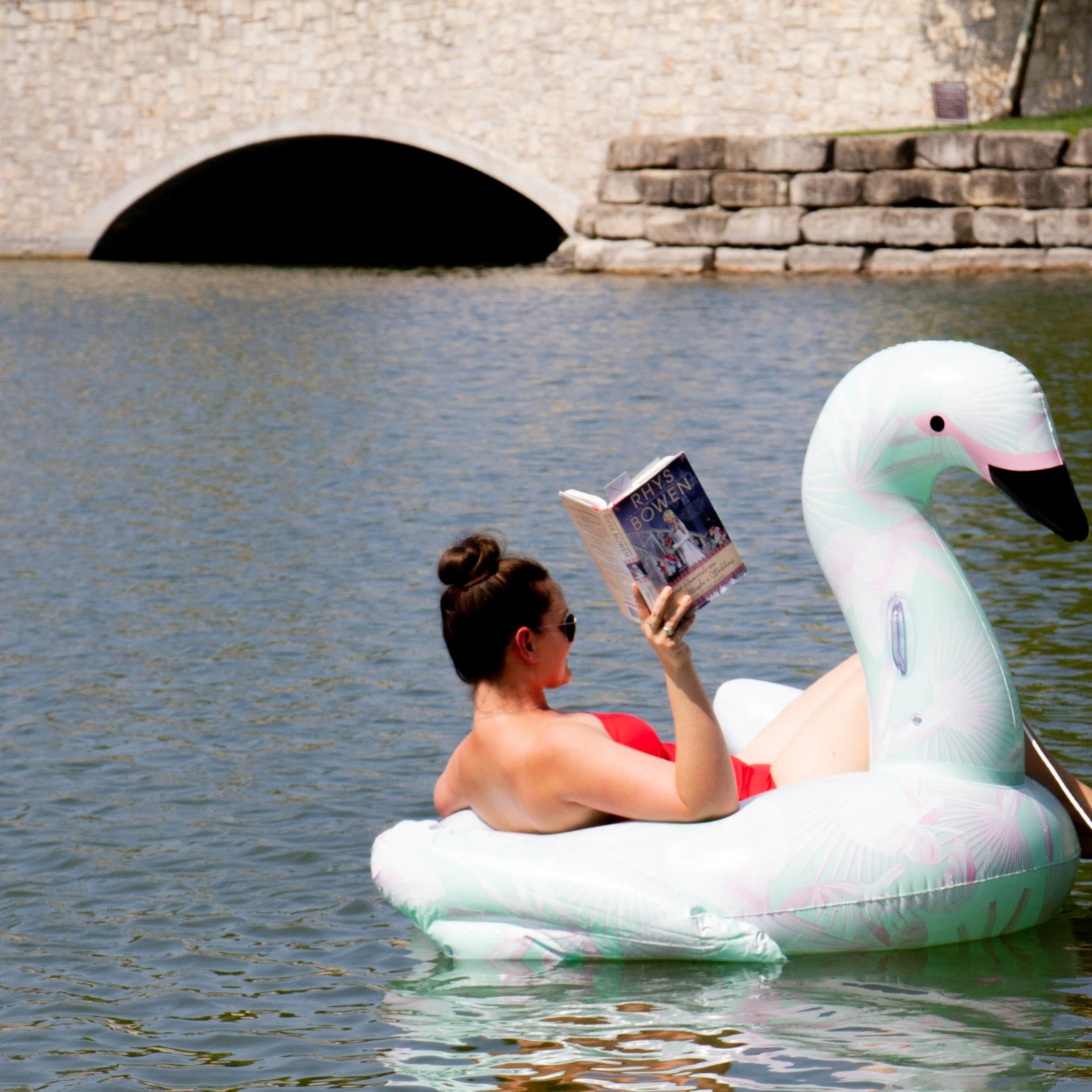 Reading Four Funerals and Maybe a Wedding by Rhys Bowen on the lake at New Town in St. Charles
