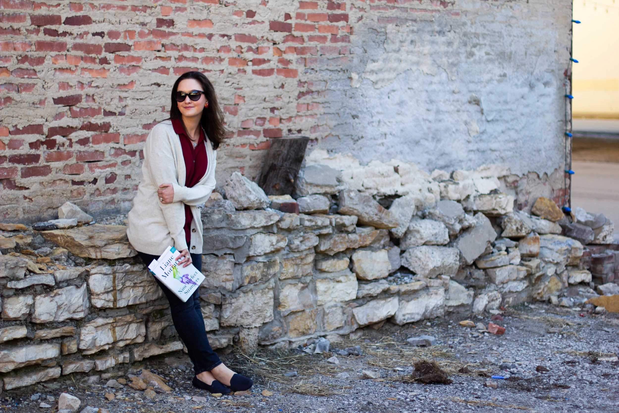 Reading Nine Perfect Strangers by Liane Moriarty in the Historic West Bottoms district of Kansas City, MO
