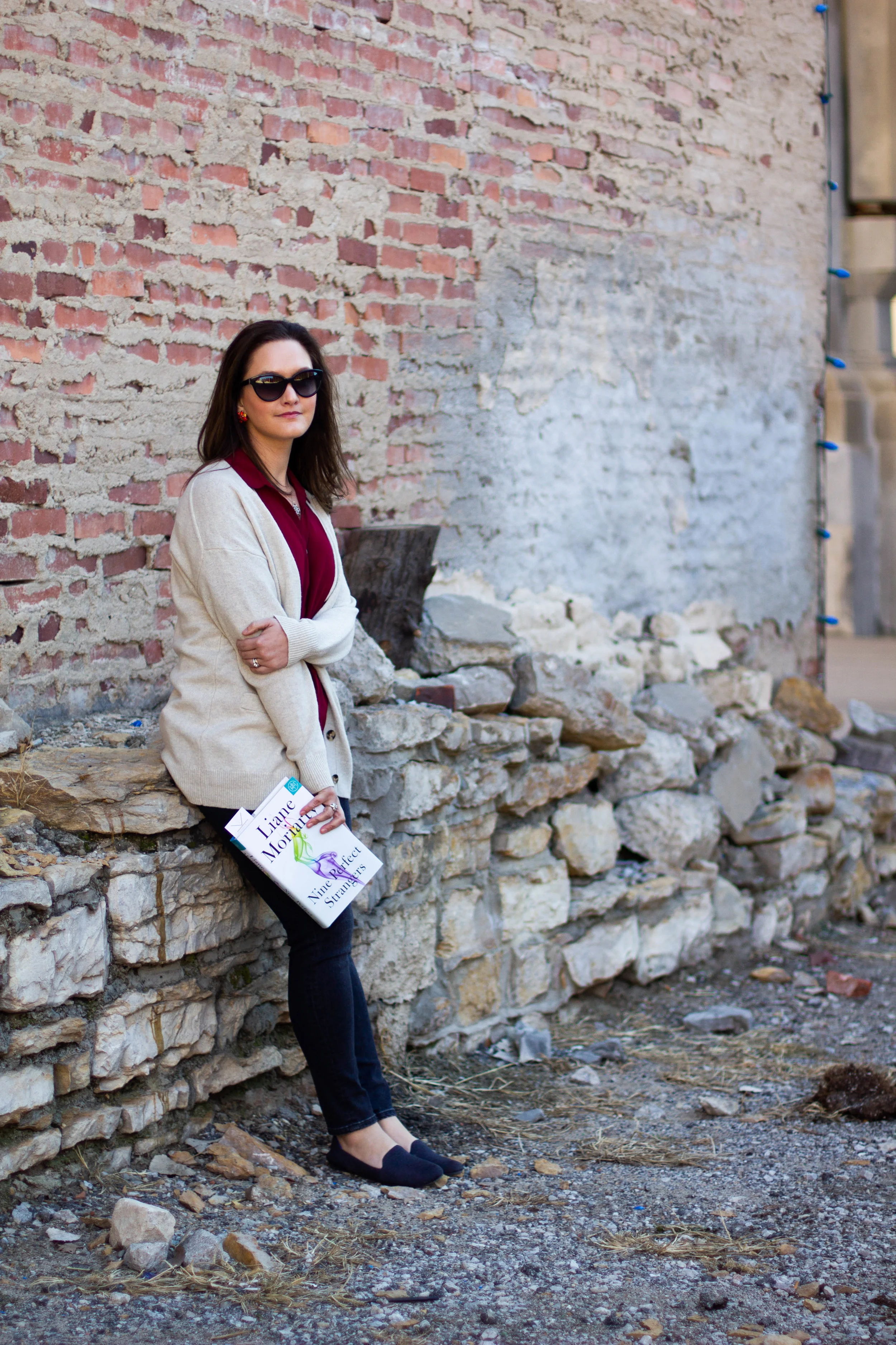 Reading Nine Perfect Strangers by Liane Moriarty in the Historic West Bottoms district of Kansas City, MO