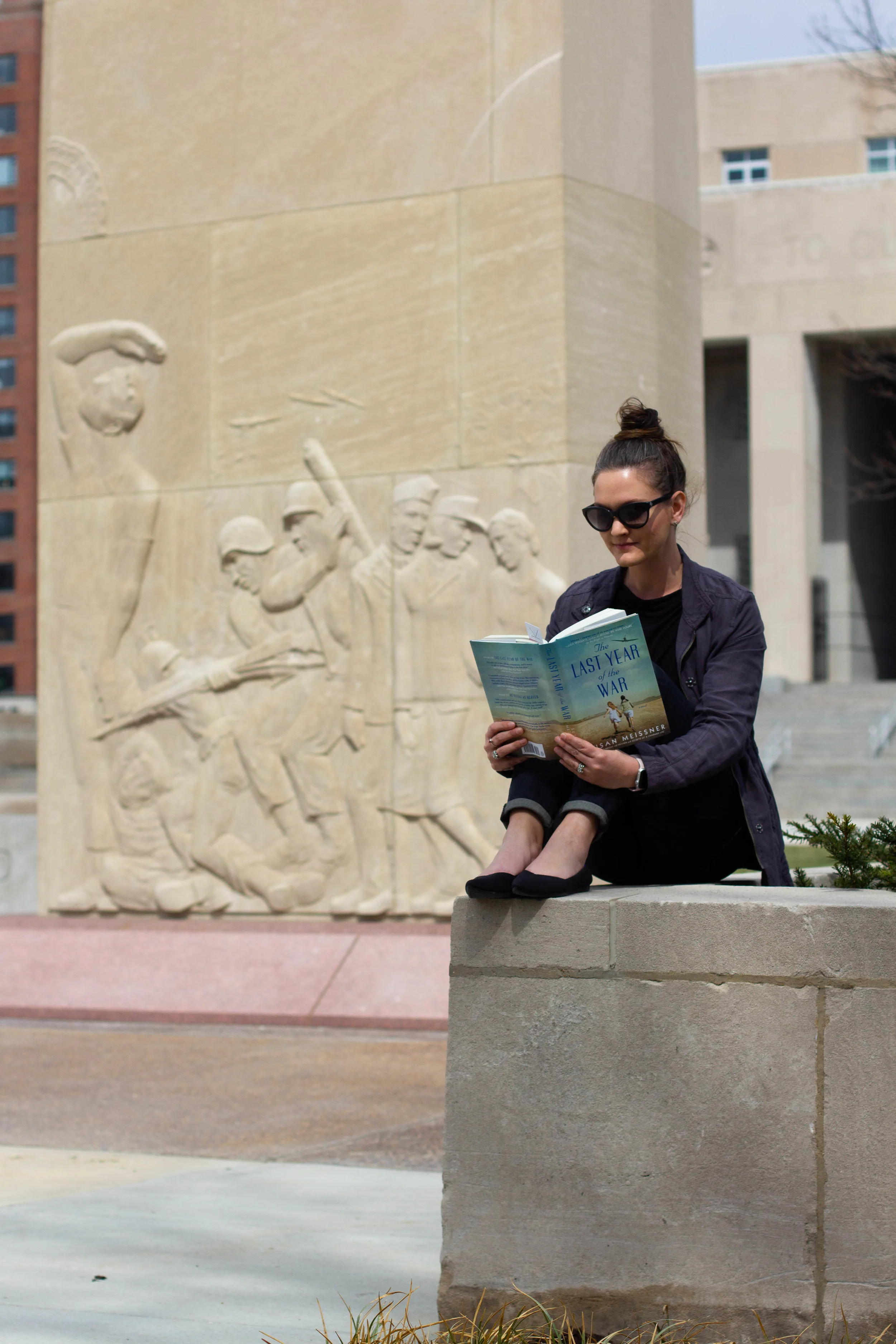 Reading The Last Year of the War by Susan Meissner at the Court of Honor, a monument in honor of WWII victims in St. Louis, MO