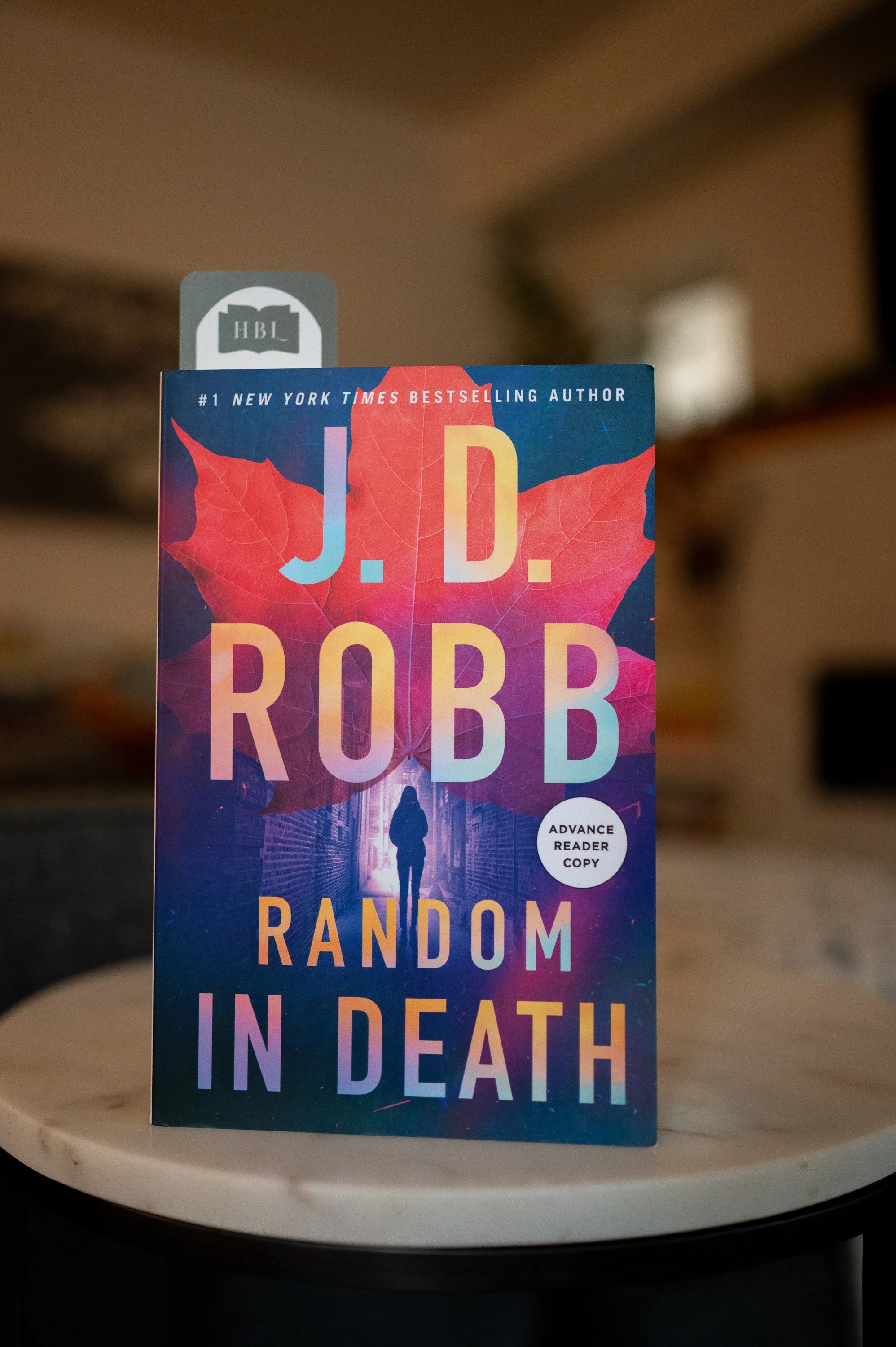  A book cover with the title 'Random in Death' by J.D. Robb. A thrilling mystery novel awaits! 