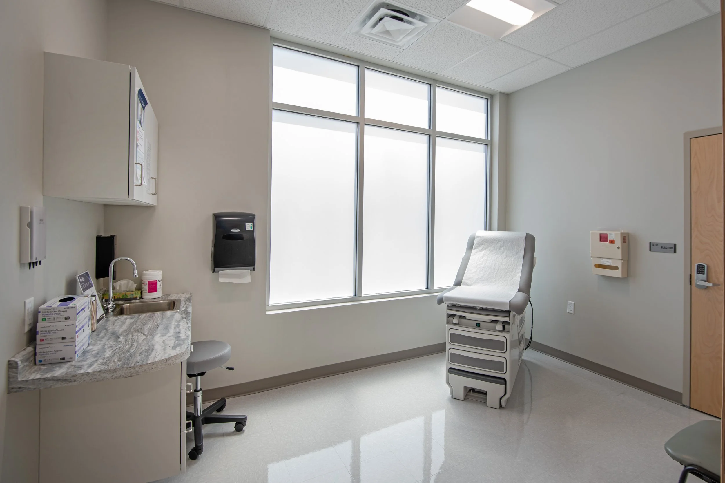 patient exam room with exam table, cabinets and window