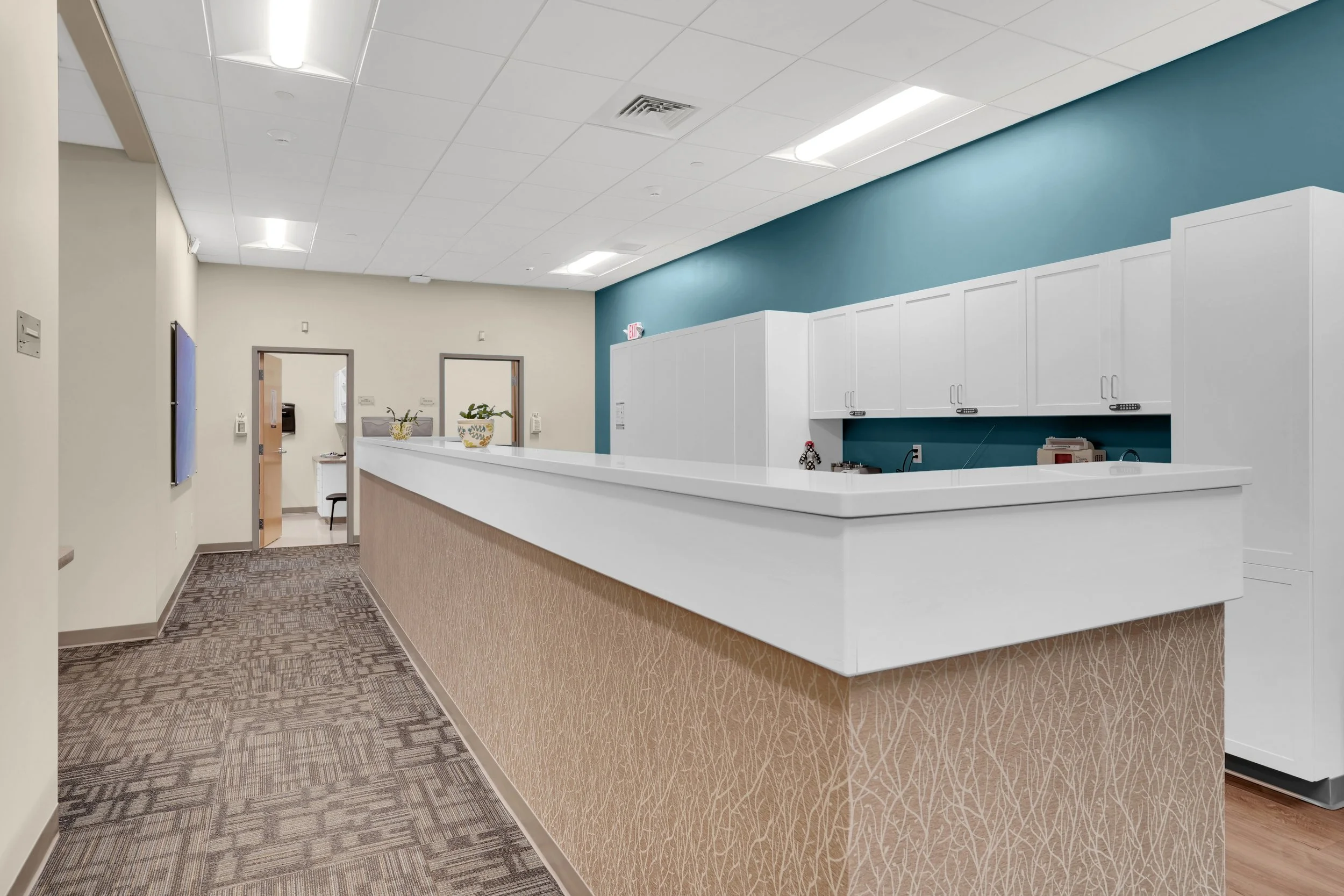 nurses stations in hallway with counter and cabinets