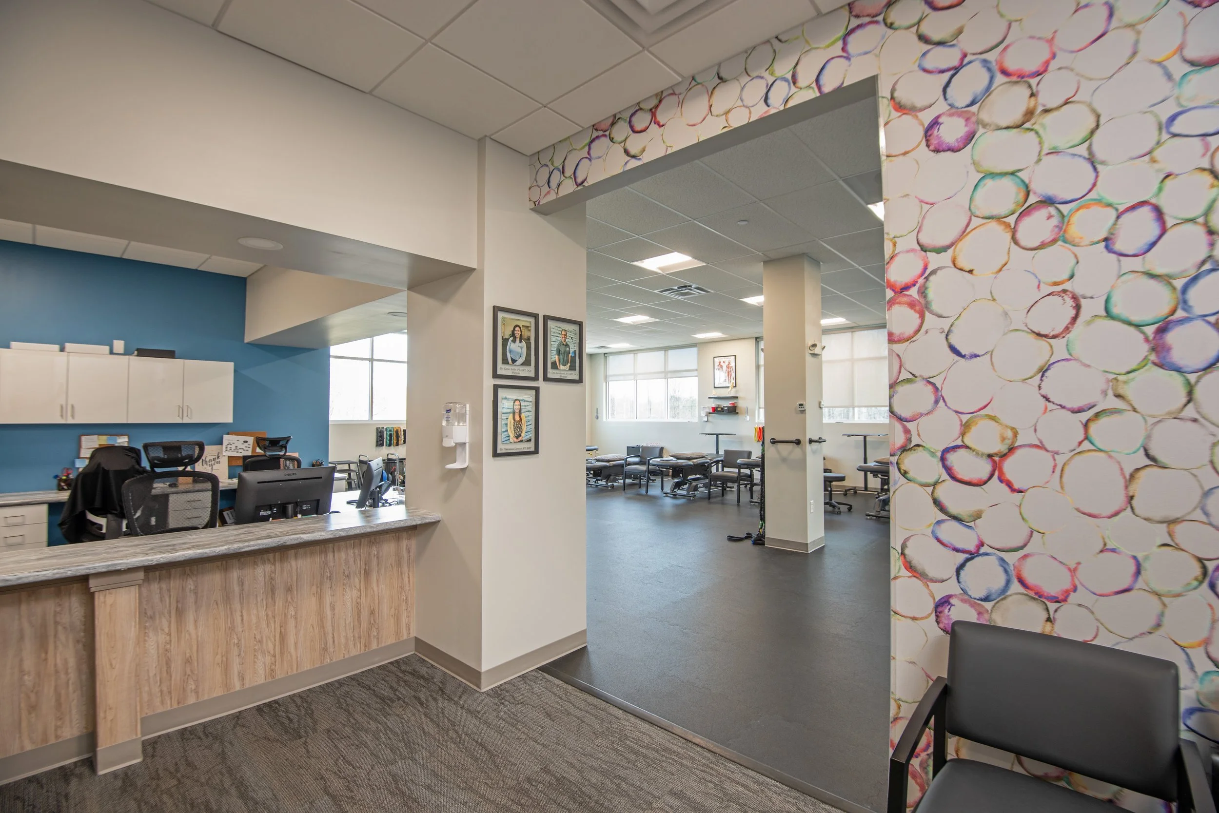 physical therapy office with therapist desk and rehabilitation room