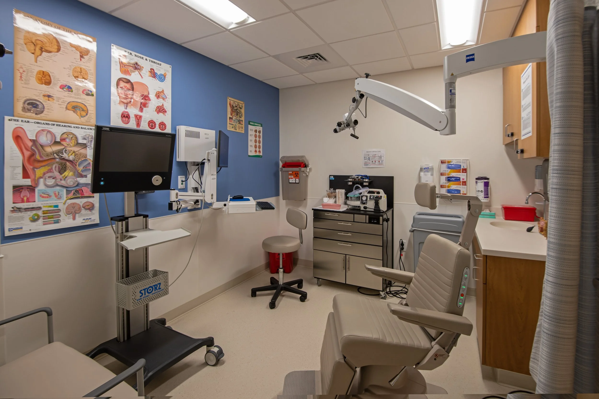 medical exam room with chair and medical devices