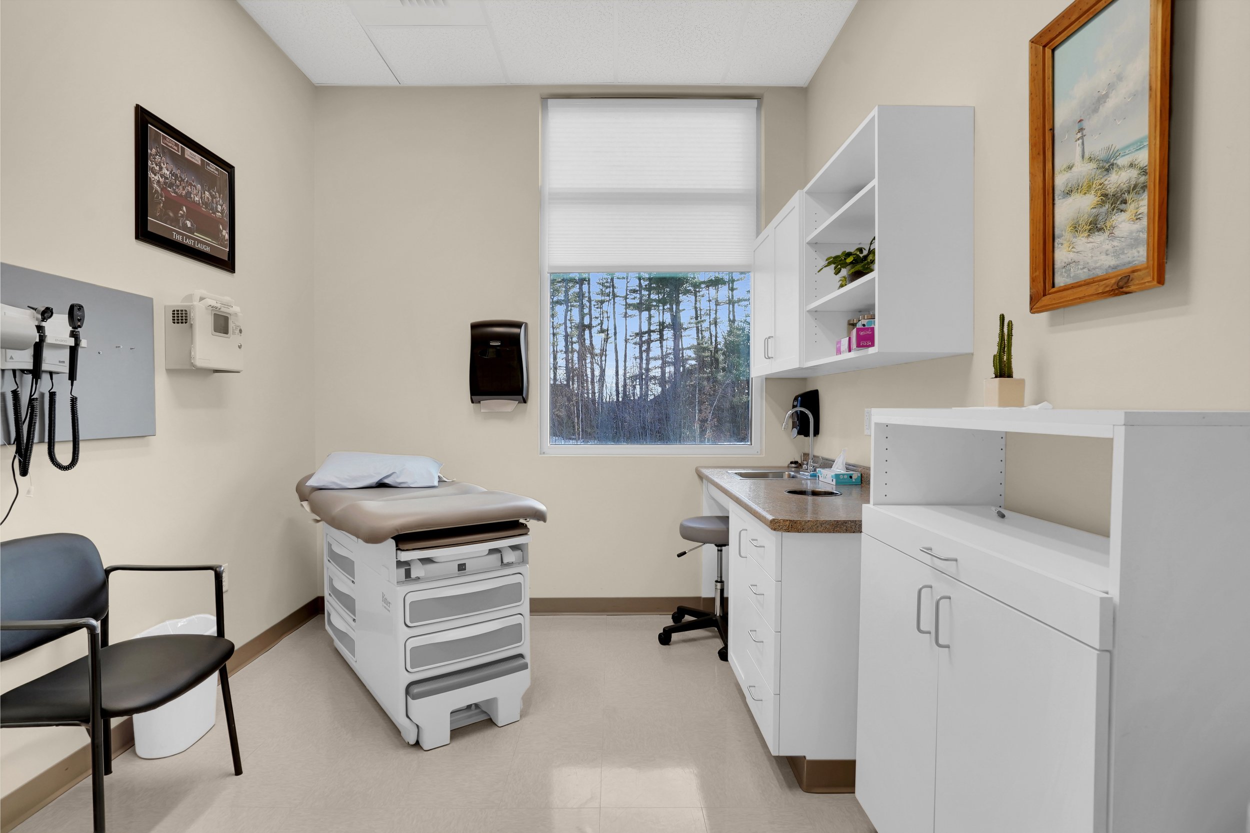 patient exam room with exam table, counters and medical devices