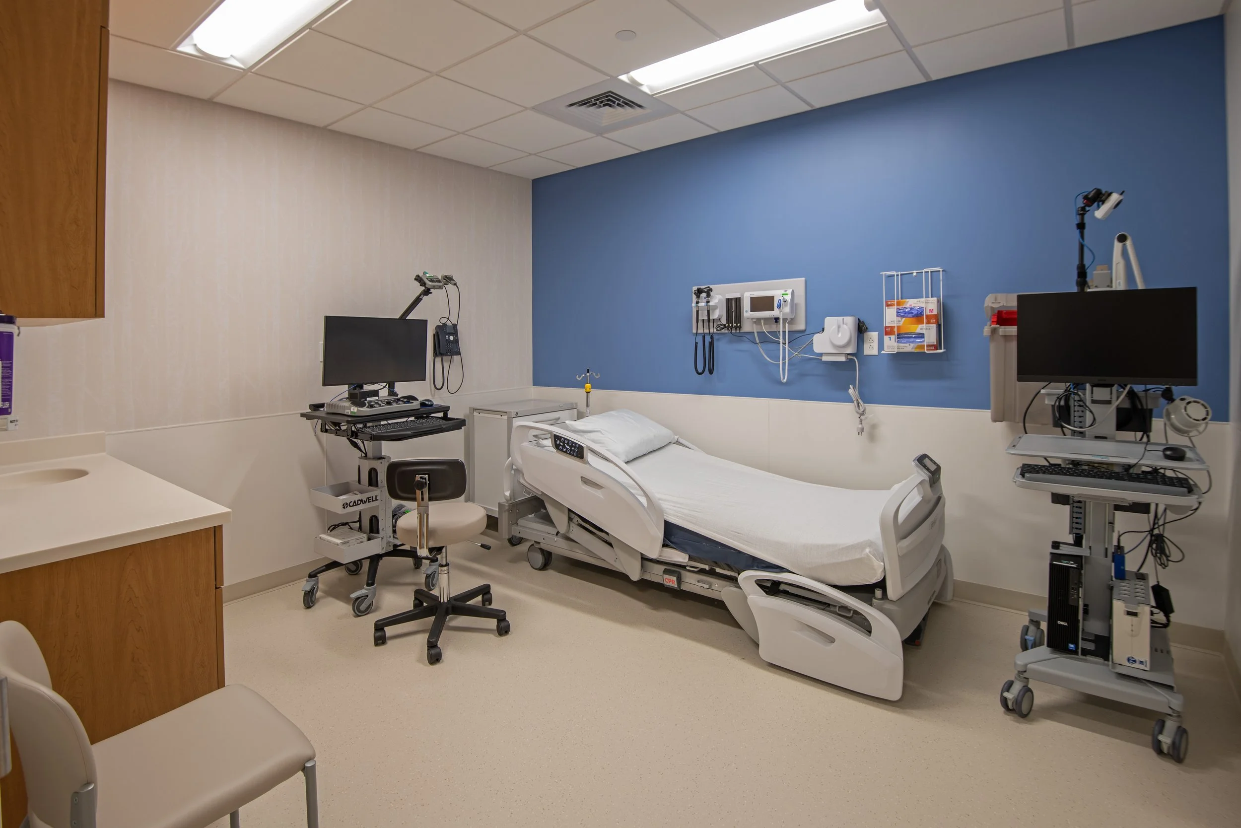 patient exam room with bed and medical devices