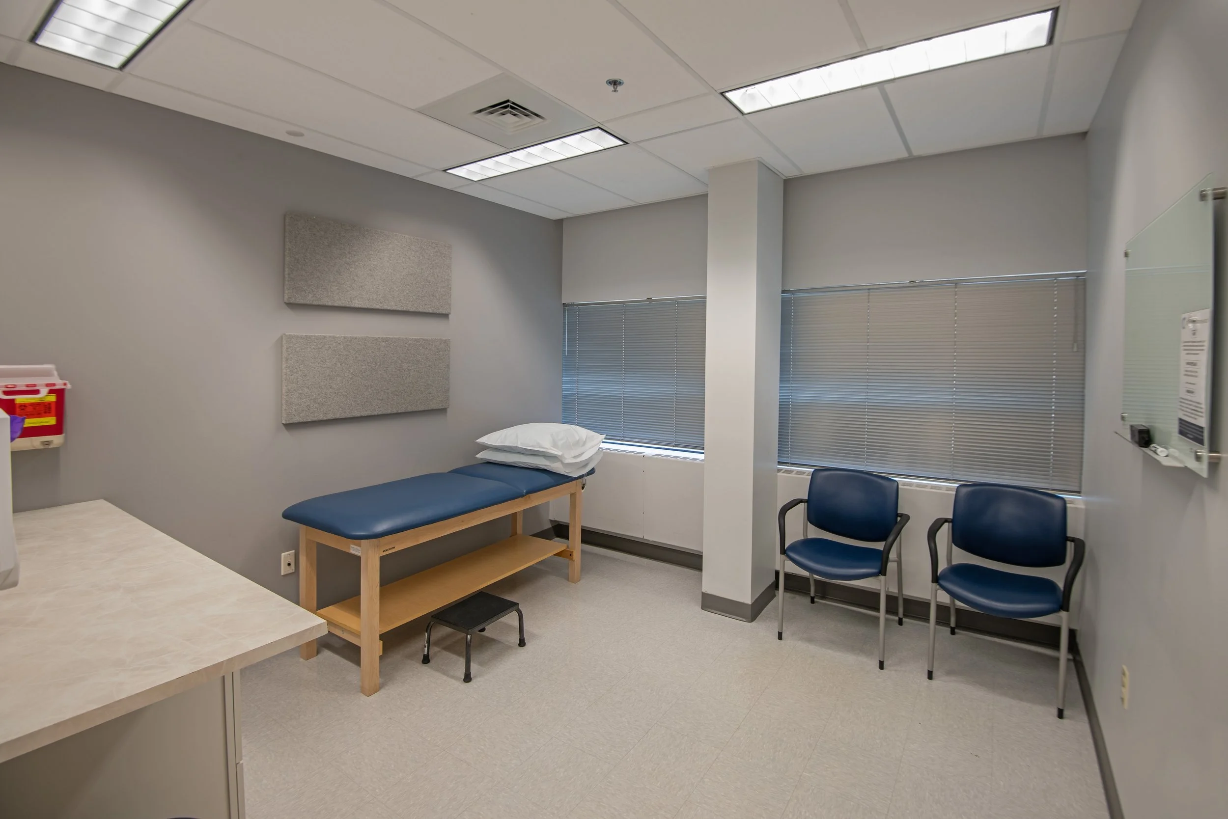 patient exam room with bed and chairs