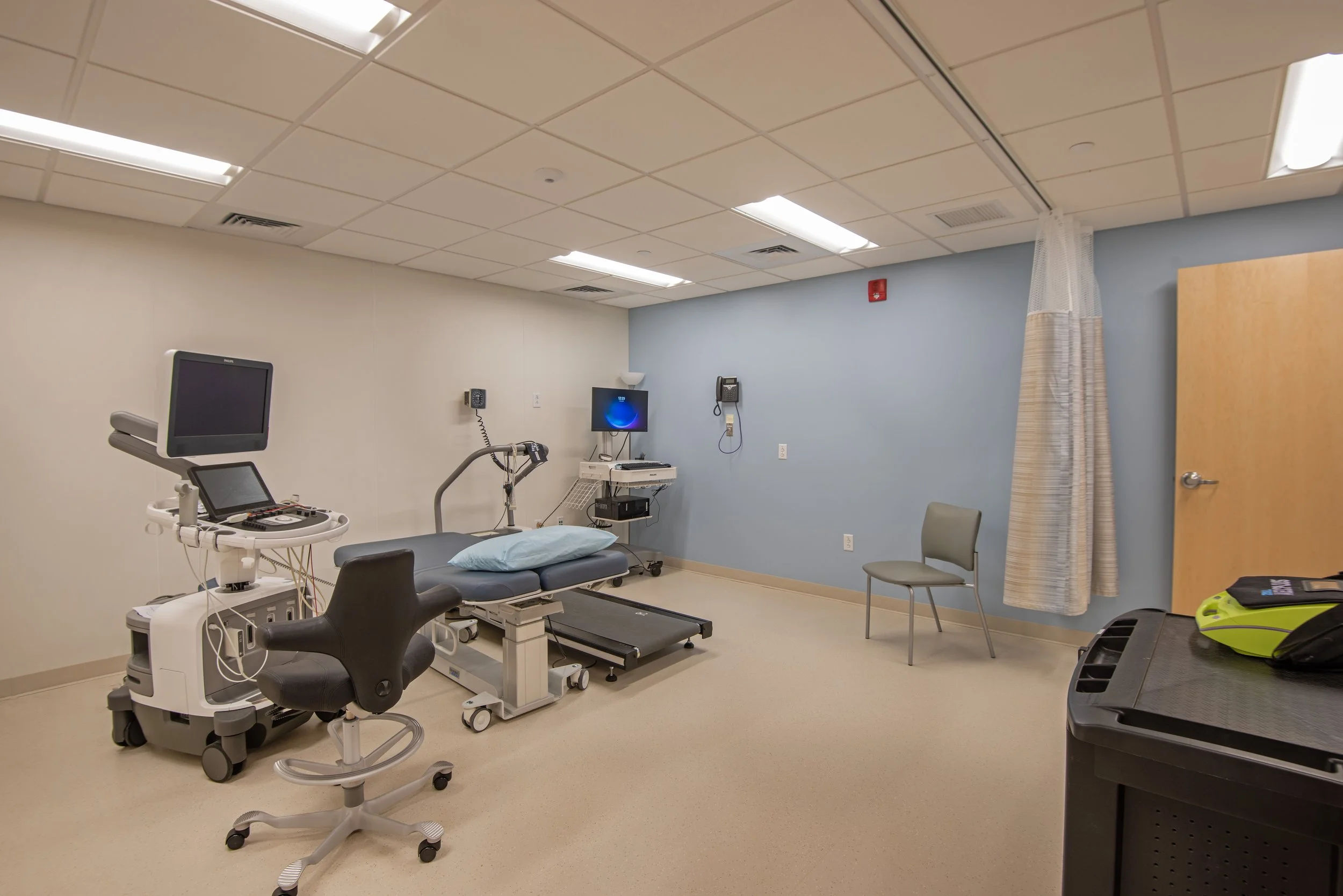 patient exam room with treadmill and medical devices