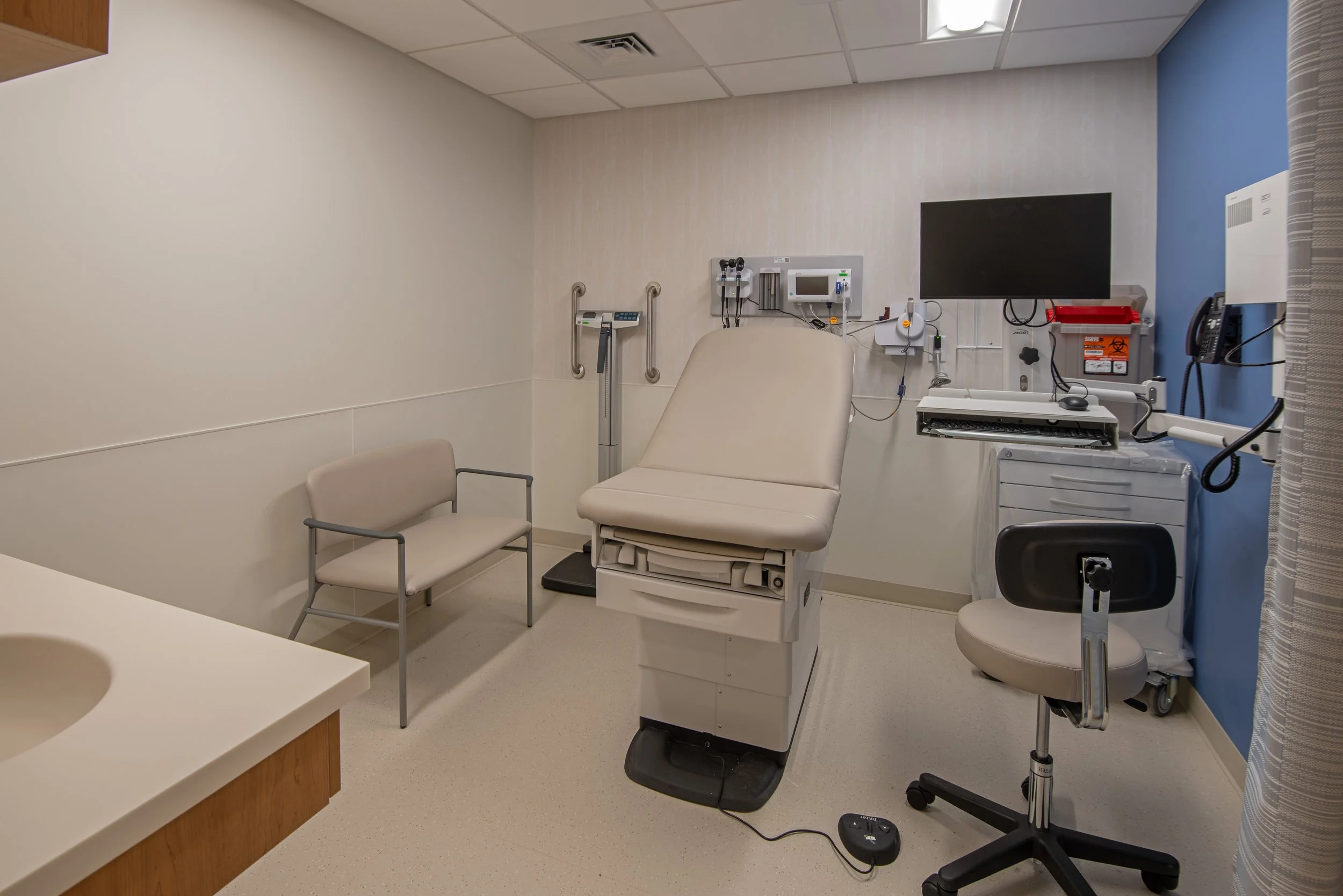 Patient exam room with table and medical devices