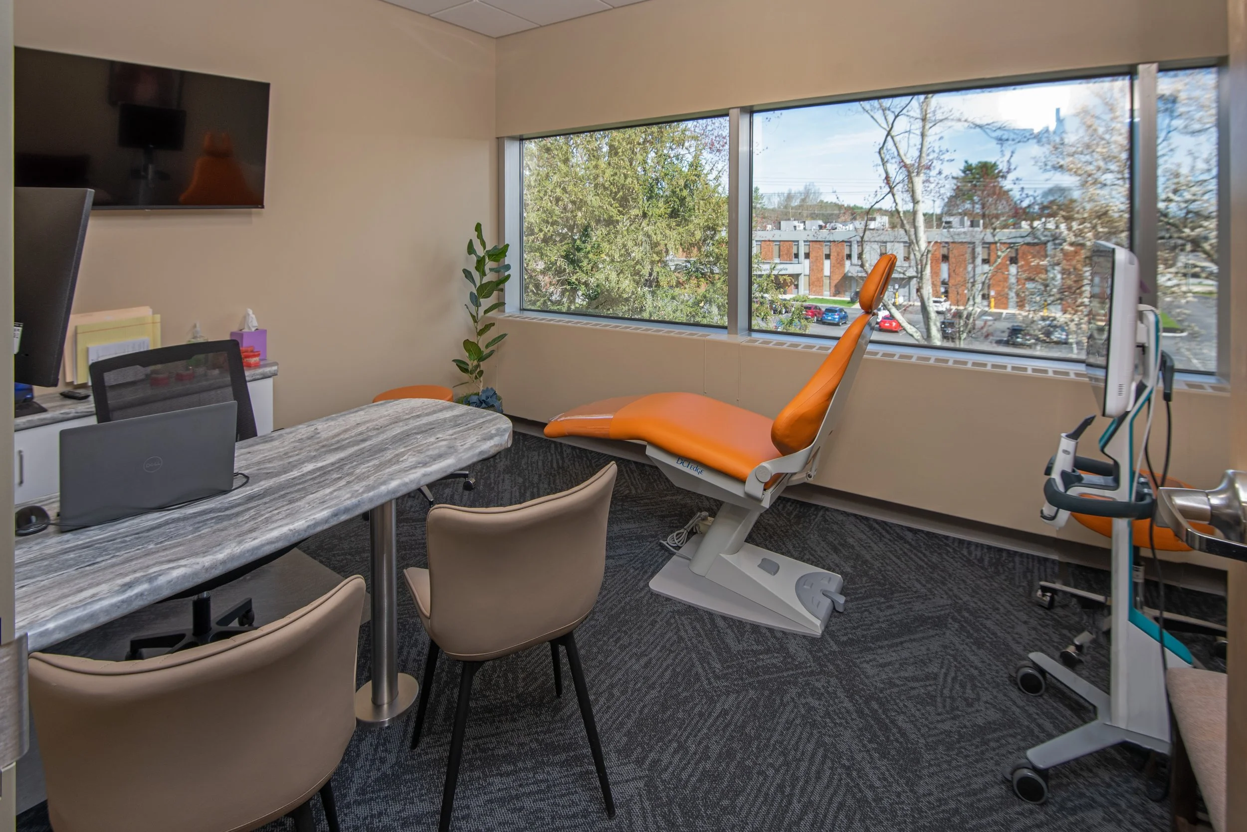 orthodontist exam room with treatment chair and conference table