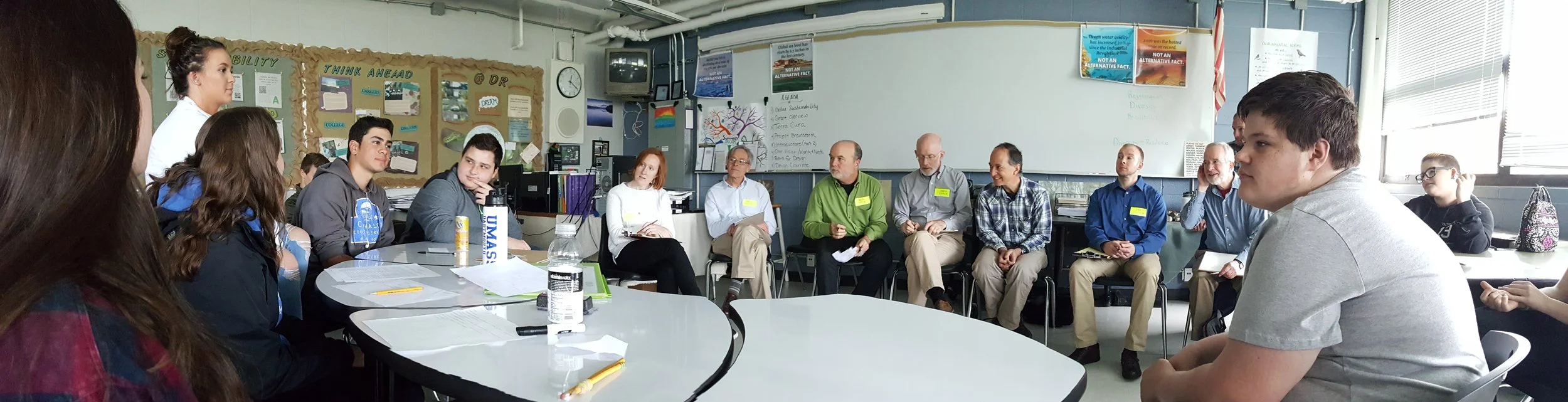 Team of educators, builders, climate monitoring experts, architects, engineers engaging students in a discussion of the Green Innovation Center program