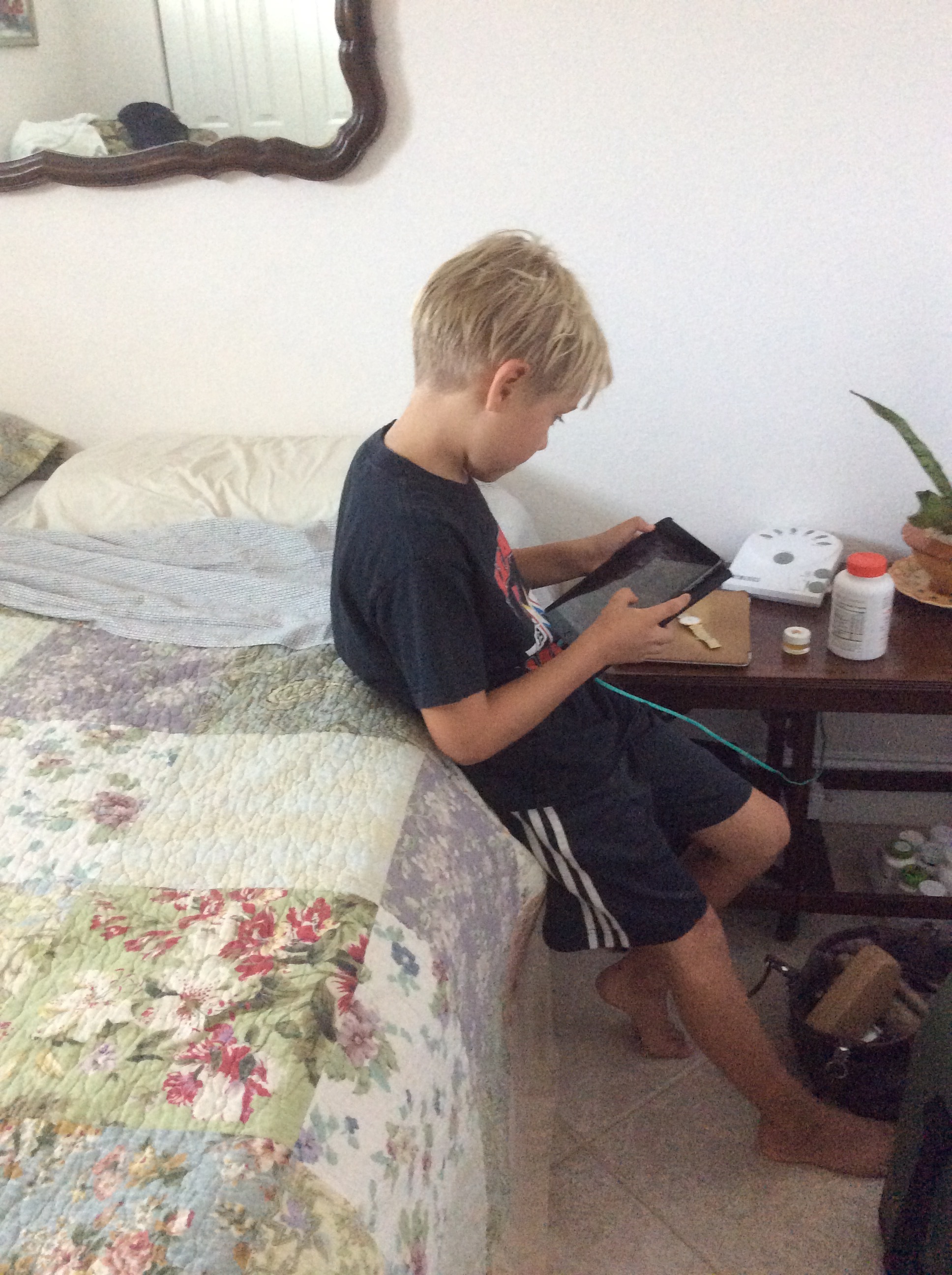 Tyler on his i-pad again sadly we can't go on the beach till 2:00 because my dad doesn't want us to get burnt. 