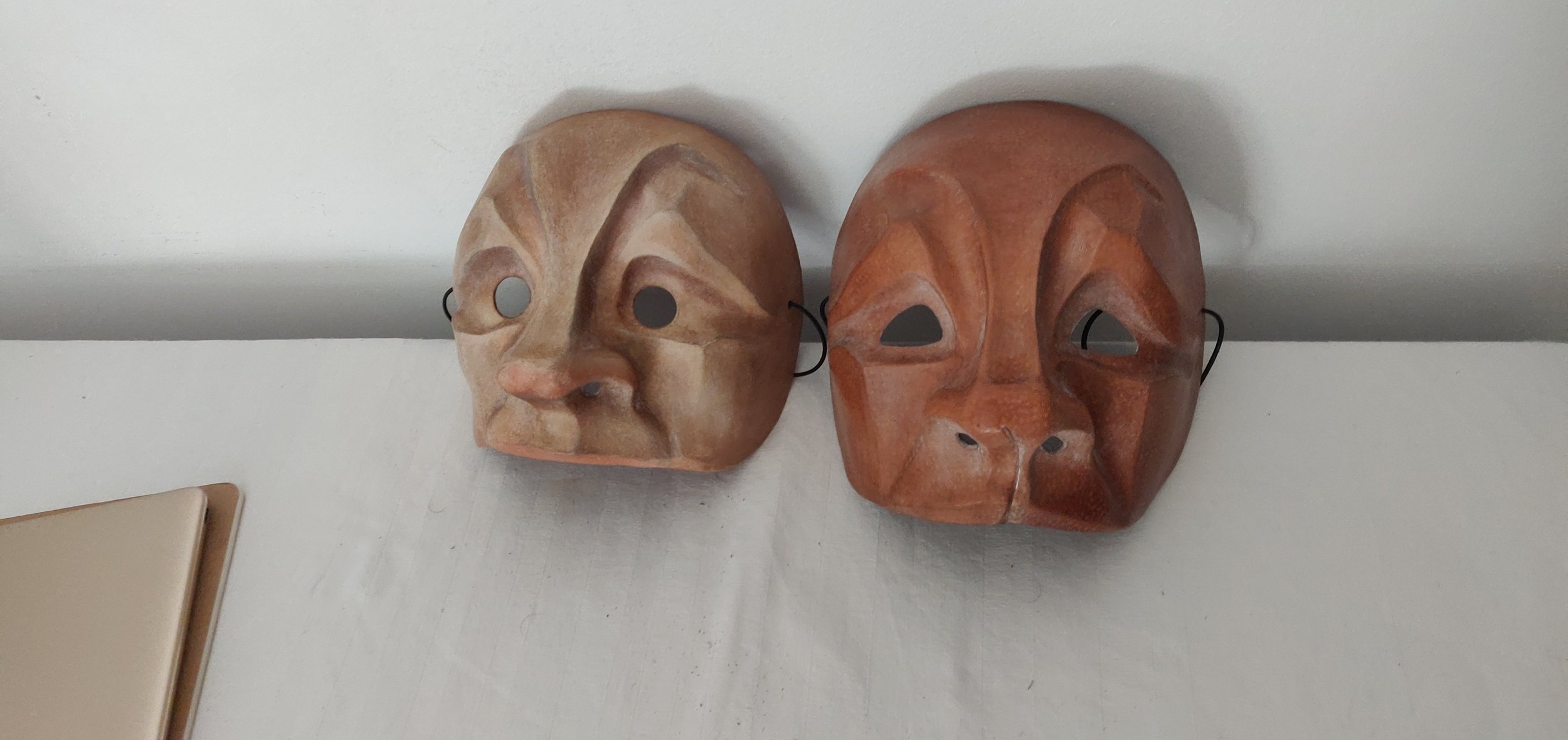 Complete masks, papier mache and leather (L-R)